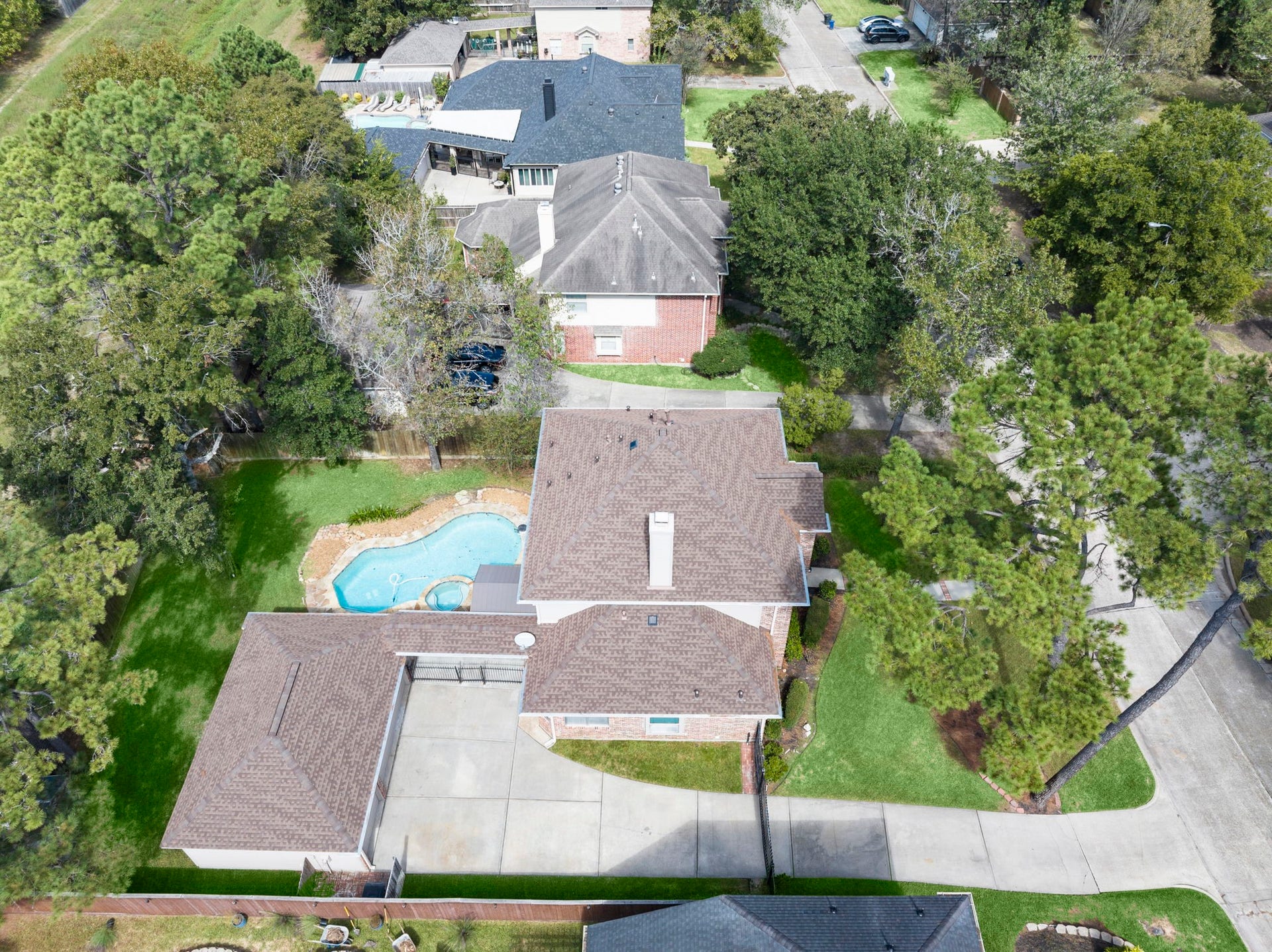 24815 Giltspur Way, Spring, TX 77389 NOW THAT'S CURB APPEAL FROM ABOVE! Just look at that gorgeous newer roof, expansive driveway with room for multiple vehicles, and beautiful canopy of mature shade trees! The gated drive provides added privacy, while lush landscaping and generous green space surround this beautifully situated home. A picture-perfect setting from every angle!