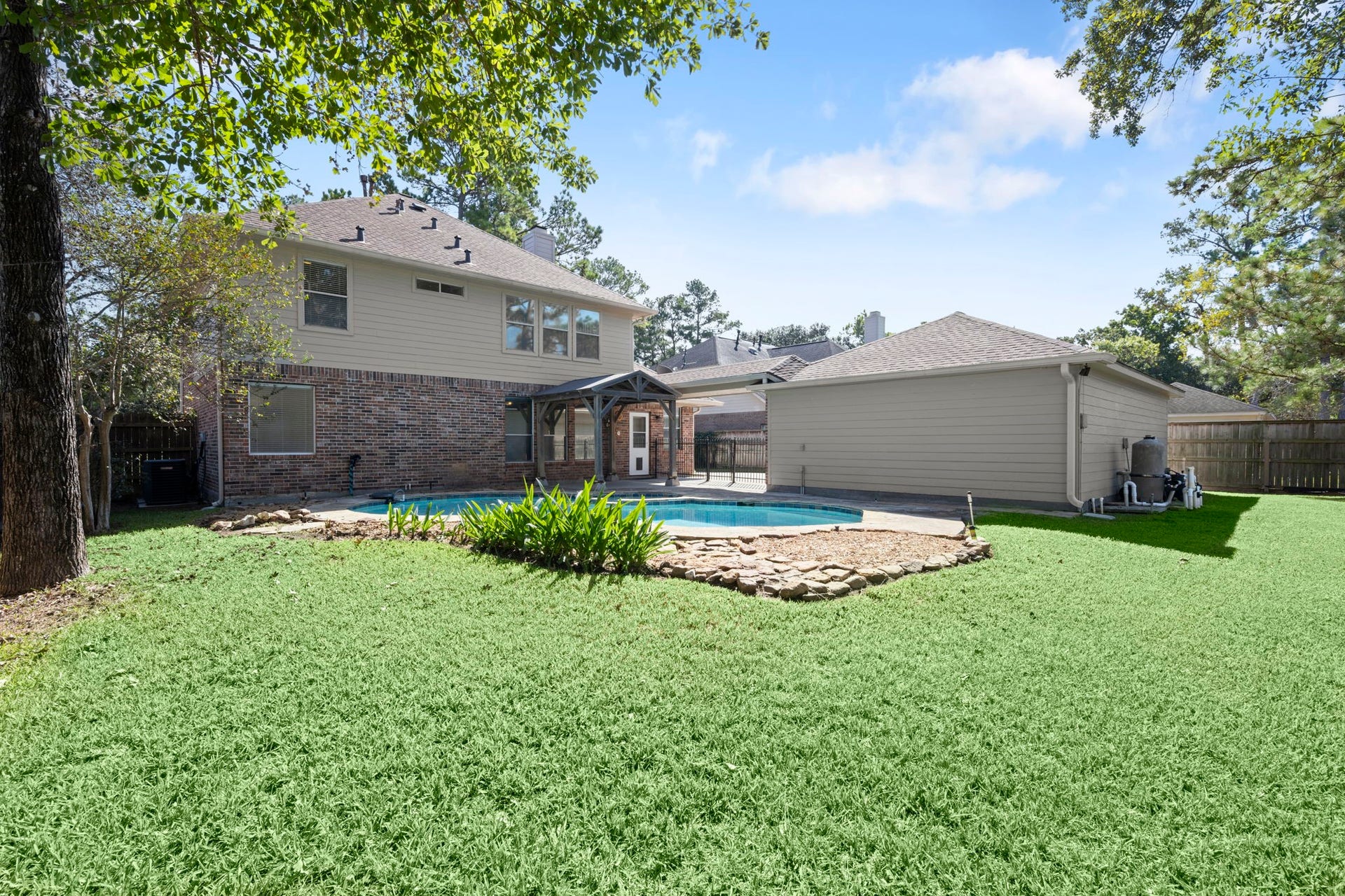 24815 Giltspur Way, Spring, TX 77389 YOUR PRIVATE BACKYARD OASIS! Sparkling freeform pool, mature shade trees, lush landscaping, and plenty of green space for Fido, a playset, or family gatherings! Attractive brick and Hardie siding exterior, newer roof, and LeafGuard gutters offer added peace of mind. Outdoor living at its finest!
