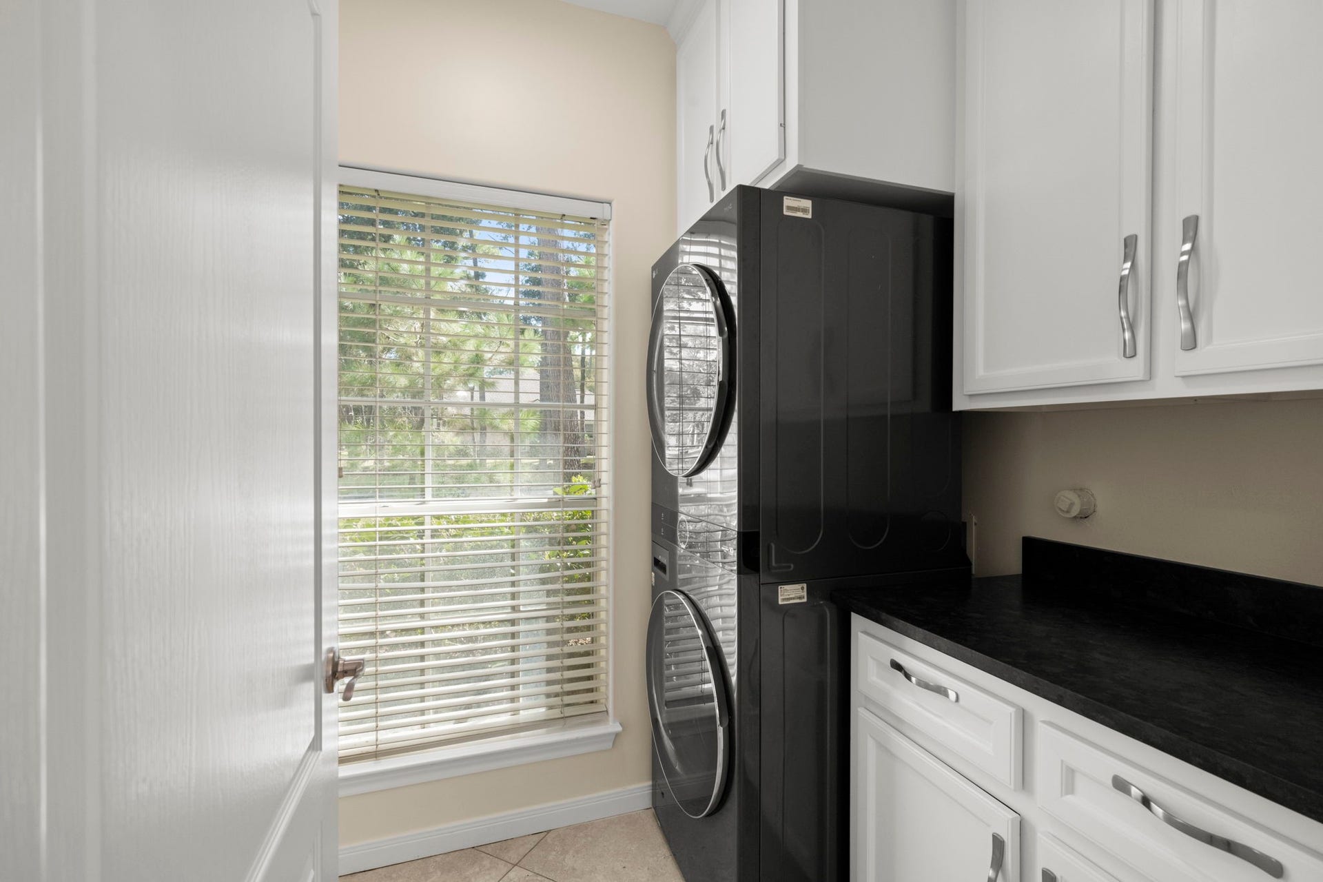 24815 Giltspur Way, Spring, TX 77389 NOW THIS IS A LAUNDRY ROOM THAT WORKS OVERTIME! This generously sized 11 x 6 IN-HOUSE UTILITY ROOM offers SO MUCH MORE than a place to wash clothes! Enjoy a full-size stacked washer & dryer, spacious folding counter, CUSTOM BUILT-IN CABINETRY, drawers & FLOOR-TO-CEILING STORAGE tucked behind the door! Plenty of room for cleaning supplies, household essentials, vacuum cleaners & even those bulky kitchen appliancesslow cookers, blenders & more!