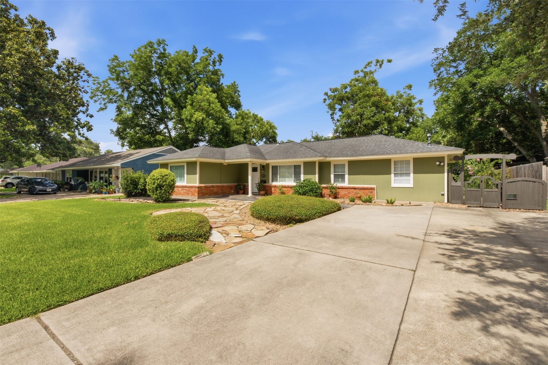 410 Kyle Street, Sugar Land, TX 77478 The wide driveway offers plenty of parking, while the home's setback creates an open, spacious feel. New carport not shown.