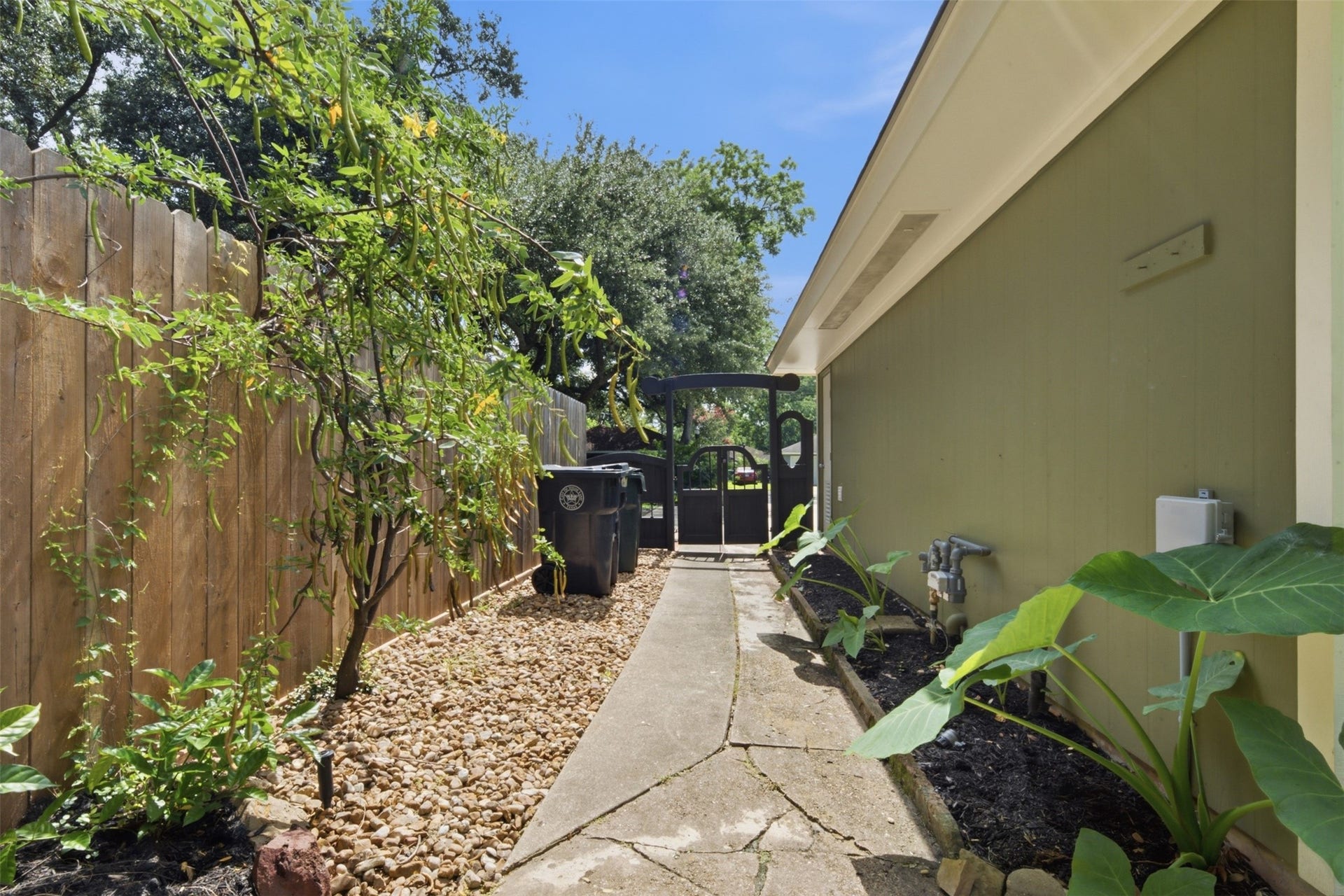 410 Kyle Street, Sugar Land, TX 77478 The newly stained entry gate provides convenient backyard access, while a storage closet houses the 2018 Rheem Classic Series Professional water heater, keeping utilities neatly tucked away.
