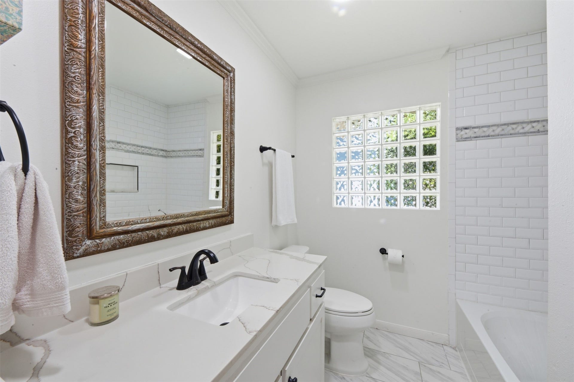 410 Kyle Street, Sugar Land, TX 77478 Serving the secondary bedrooms as well as family and friends, this renovated bathroom features a new vanity, updated plumbing fixtures, new tile flooring, a tiled tub surround, recessed lighting, a new toilet, and a large linen closet for added storage.