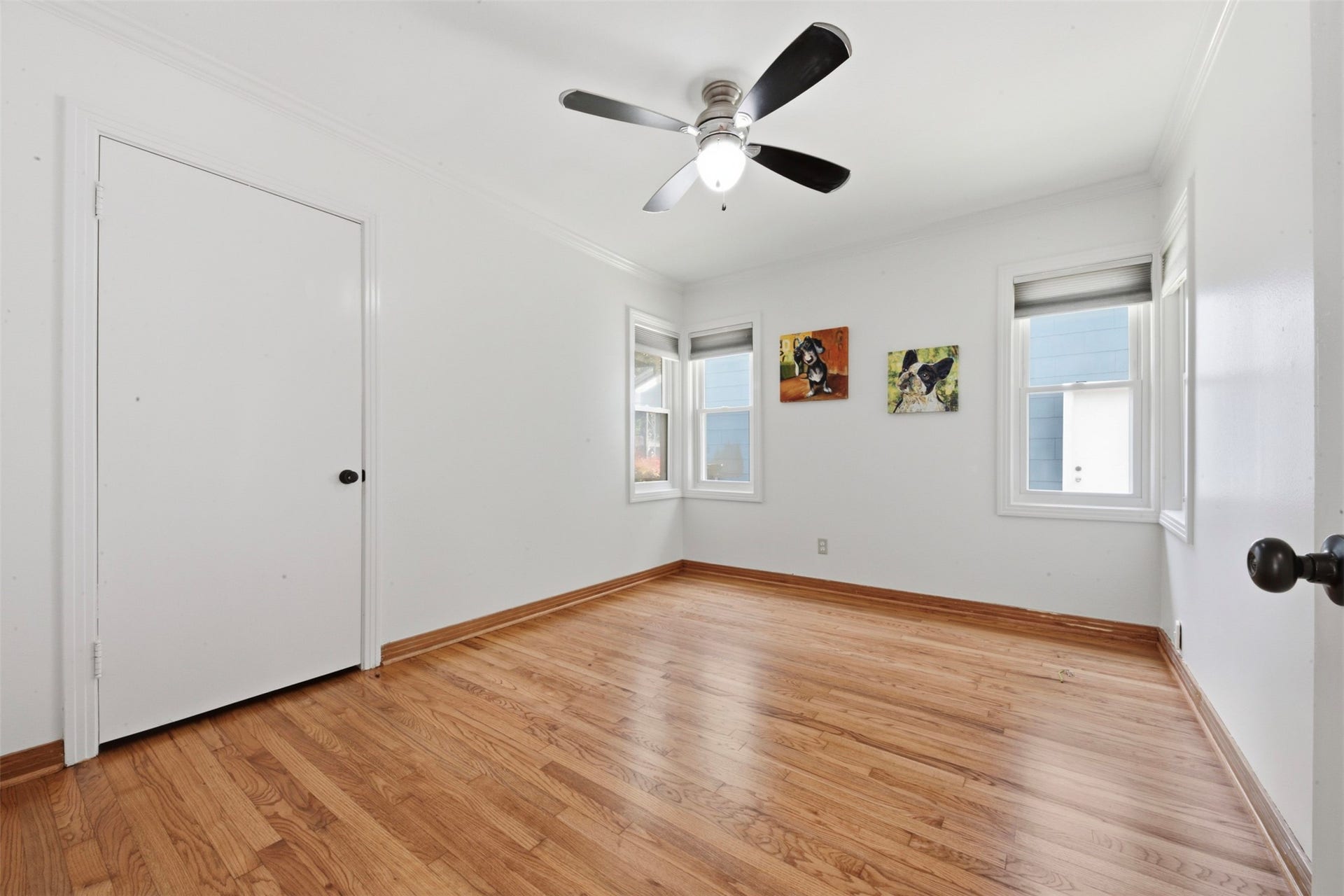410 Kyle Street, Sugar Land, TX 77478 Bedroom 3 easily adapts as a bedroom, home office, or creative space, complete with a walk-in closet, custom shades, and hardwood floors.