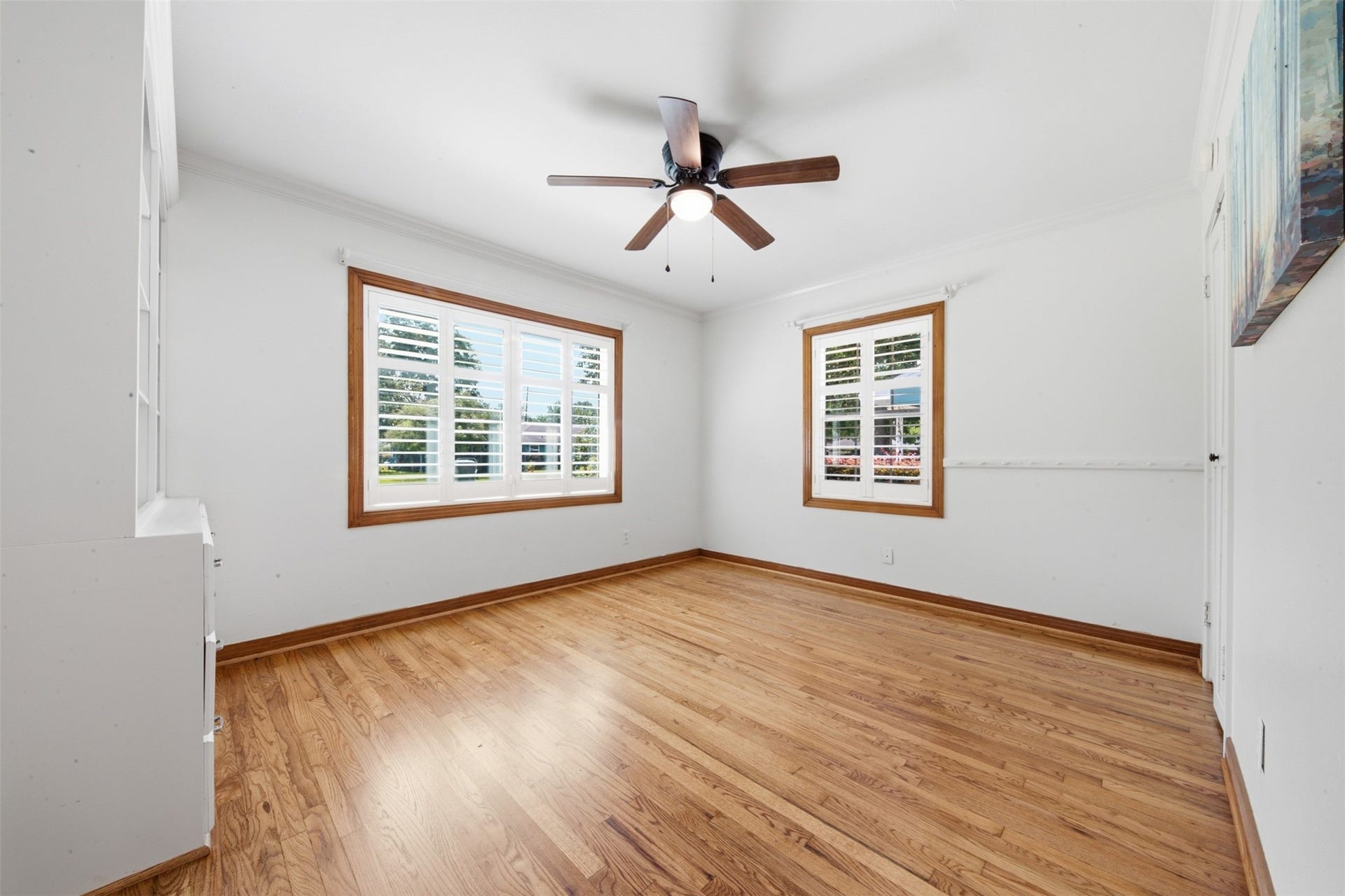 410 Kyle Street, Sugar Land, TX 77478 Custom storage built-ins provide exceptional storage, while hardwood floors, a ceiling fan, Double-Pane Low-E windows, and plantation shutters complete this secondary bedroom.