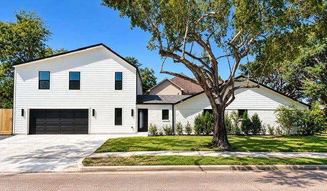 12503 Barryknoll Lane, Houston, TX 77024 Extra size parking space. New Landscaping with added shrubs for enhanced privacy and curb appeal!