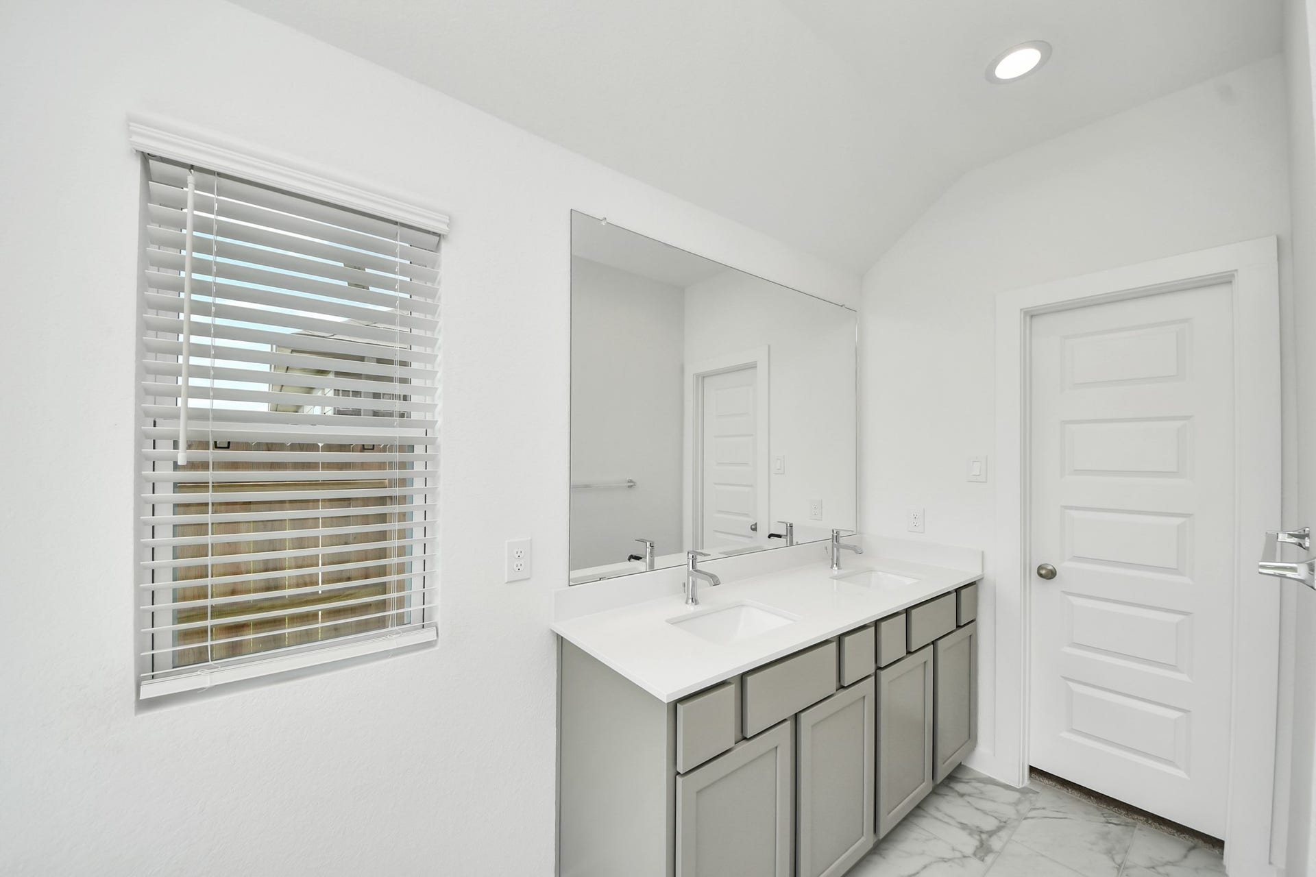 16003 Sycamore Maple Lane, Cypress, TX 77429 Elevate your daily routine at the elegant vanity, now equipped with double sinks, light countertops, modern hardware, and beautiful recessed lights.