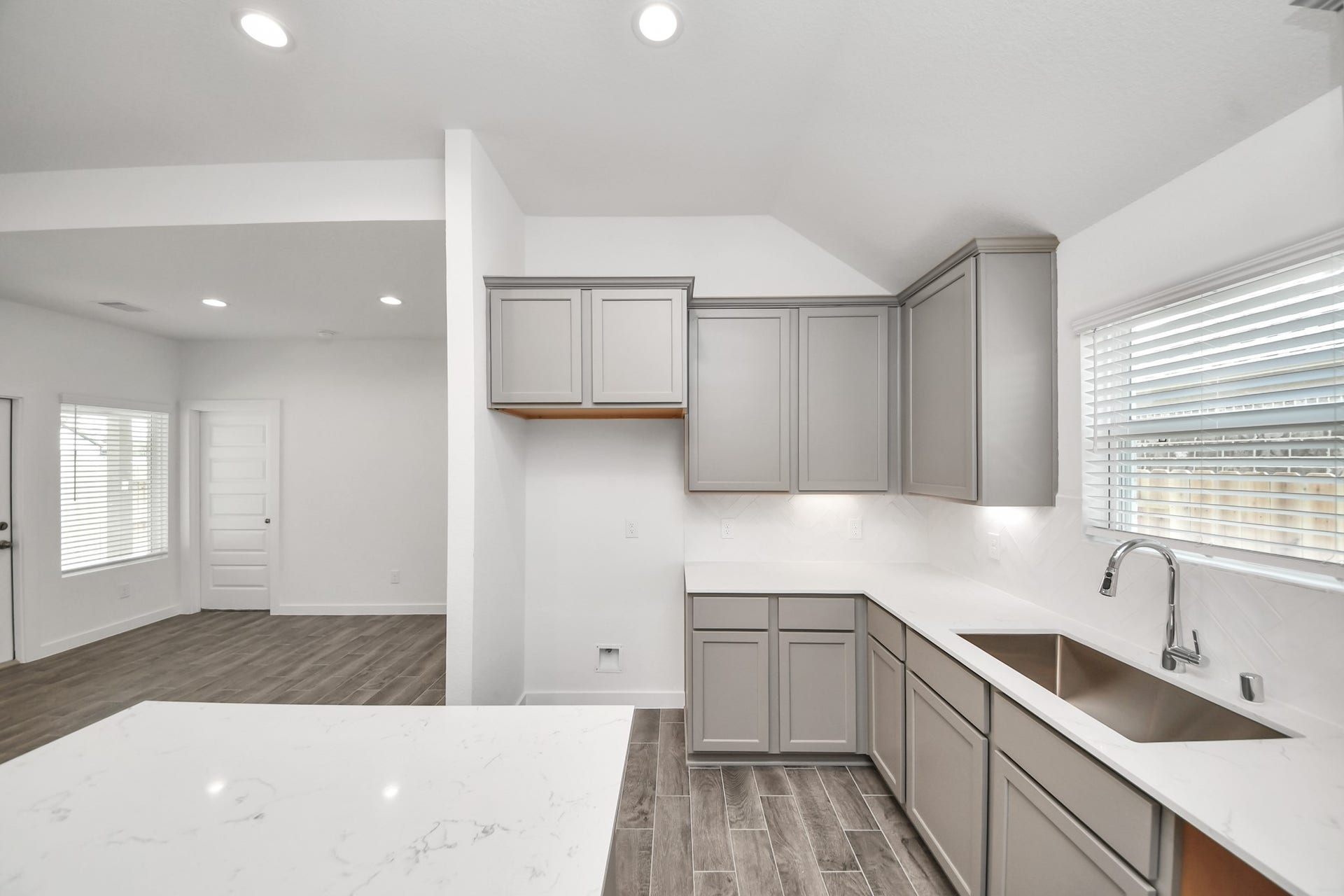 16003 Sycamore Maple Lane, Cypress, TX 77429 The extended counter area adds both practicality and style, making meal preparation a breeze. Every detail is thoughtfully designed to enhance the kitchen's functionality and aesthetic appeal.