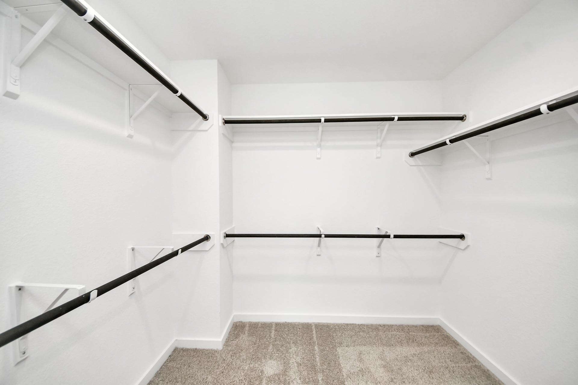16003 Sycamore Maple Lane, Cypress, TX 77429 Walk-in closet that epitomizes luxury and practicality. This generously sized space features built-in shelving, offering abundant room for impeccable organization. High ceilings and recessed lighting create a bright and welcoming ambiance.
