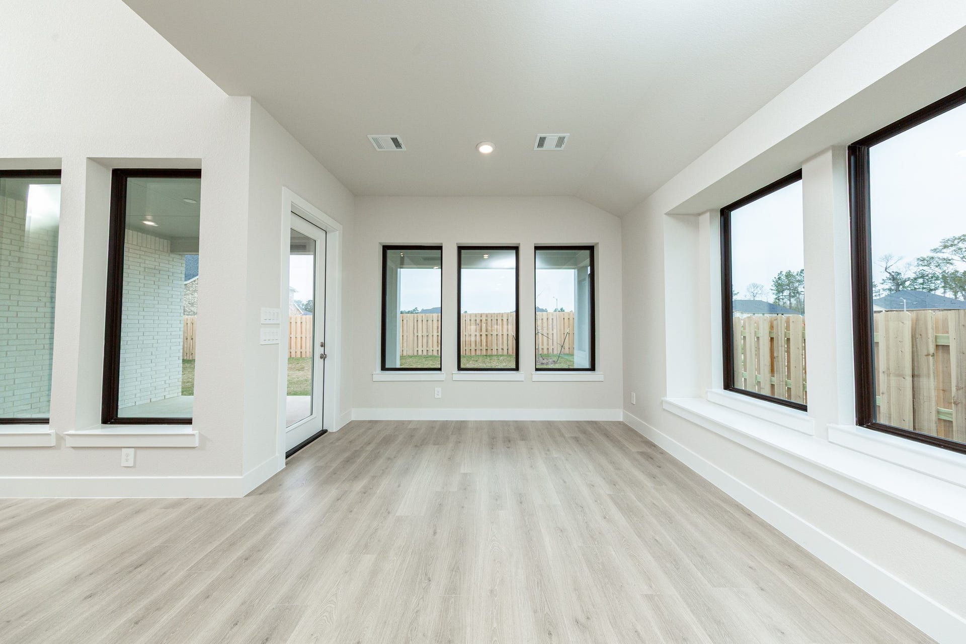 Create lasting memories around the table with family and friends in the dining! It showcases high ceilings, large windows with seating sill, laminate flooring, and recessed lighting for a warm and welcoming atmosphere.