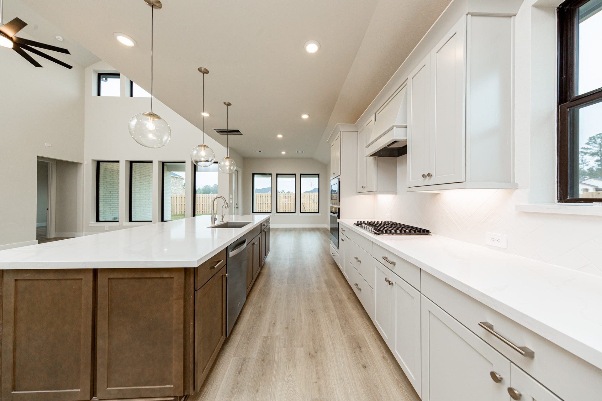 This gourmet, open-concept kitchen is truly the heart of the home, meticulously designed with both aesthetics and functionality in mind. White Shaker-style cabinetry, quartz countertops, modern backsplash and brushed nickel hardware giving it all a touch of luxury.