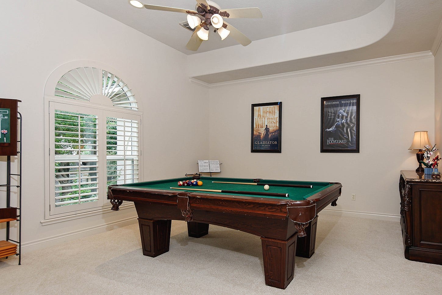 10 Snow Pond Place, The Woodlands, TX 77382 Bedroom 4 has recessed ceiling, crown molding, and custom plantation shutters on large window with walk-in closet (currently being used as a billiard/game room).
