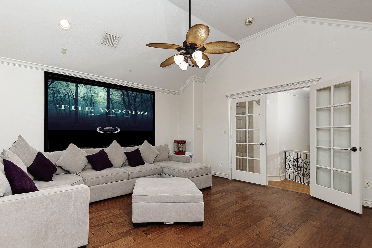 10 Snow Pond Place, The Woodlands, TX 77382 This media room features an expansive screen area that provides an ideal viewing experience from the projector on the opposite wall. Additionally, the inclusion of privacy doors serves as an excellent enhancement for enjoying the use of space.