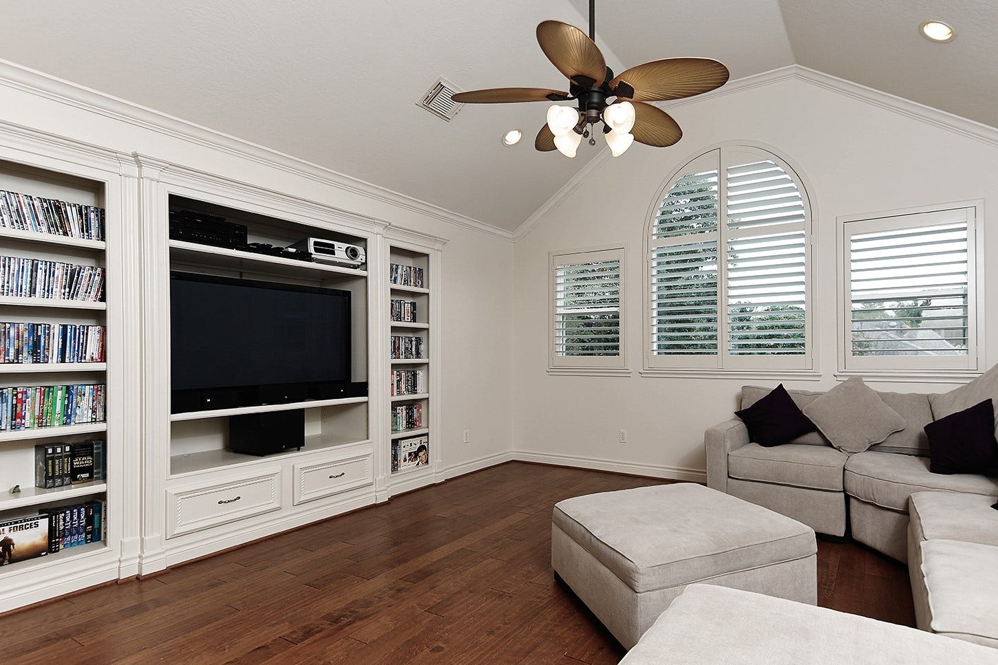 10 Snow Pond Place, The Woodlands, TX 77382 The spacious media room features a custom cabinetry installation and a professional-grade projector.