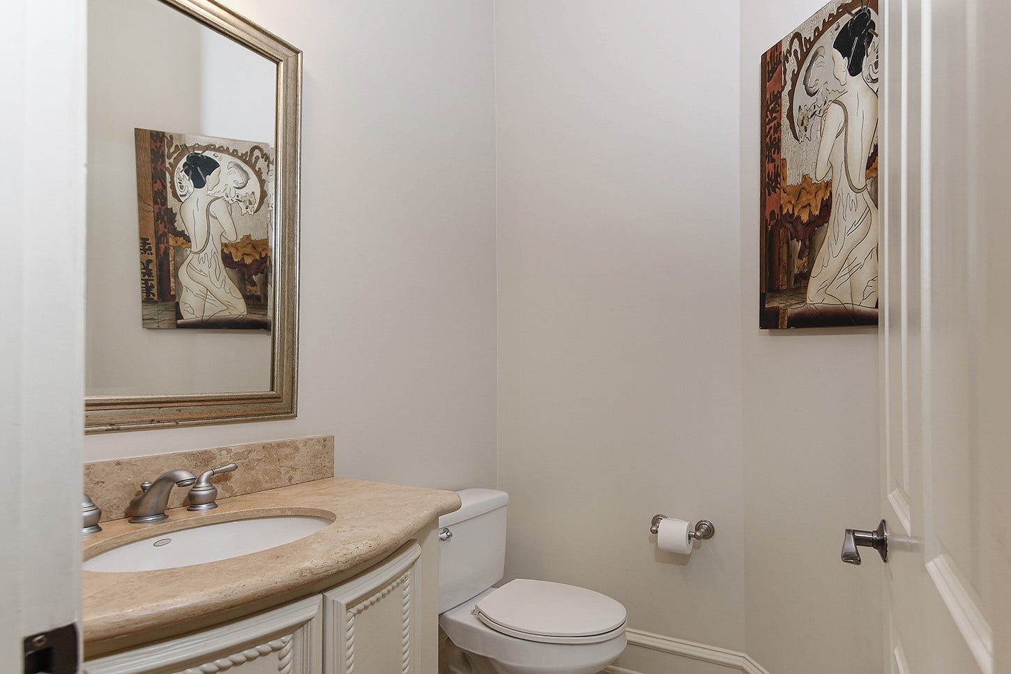 10 Snow Pond Place, The Woodlands, TX 77382 This powder room features marble countertops complemented by custom cabinetry and refined molding details.