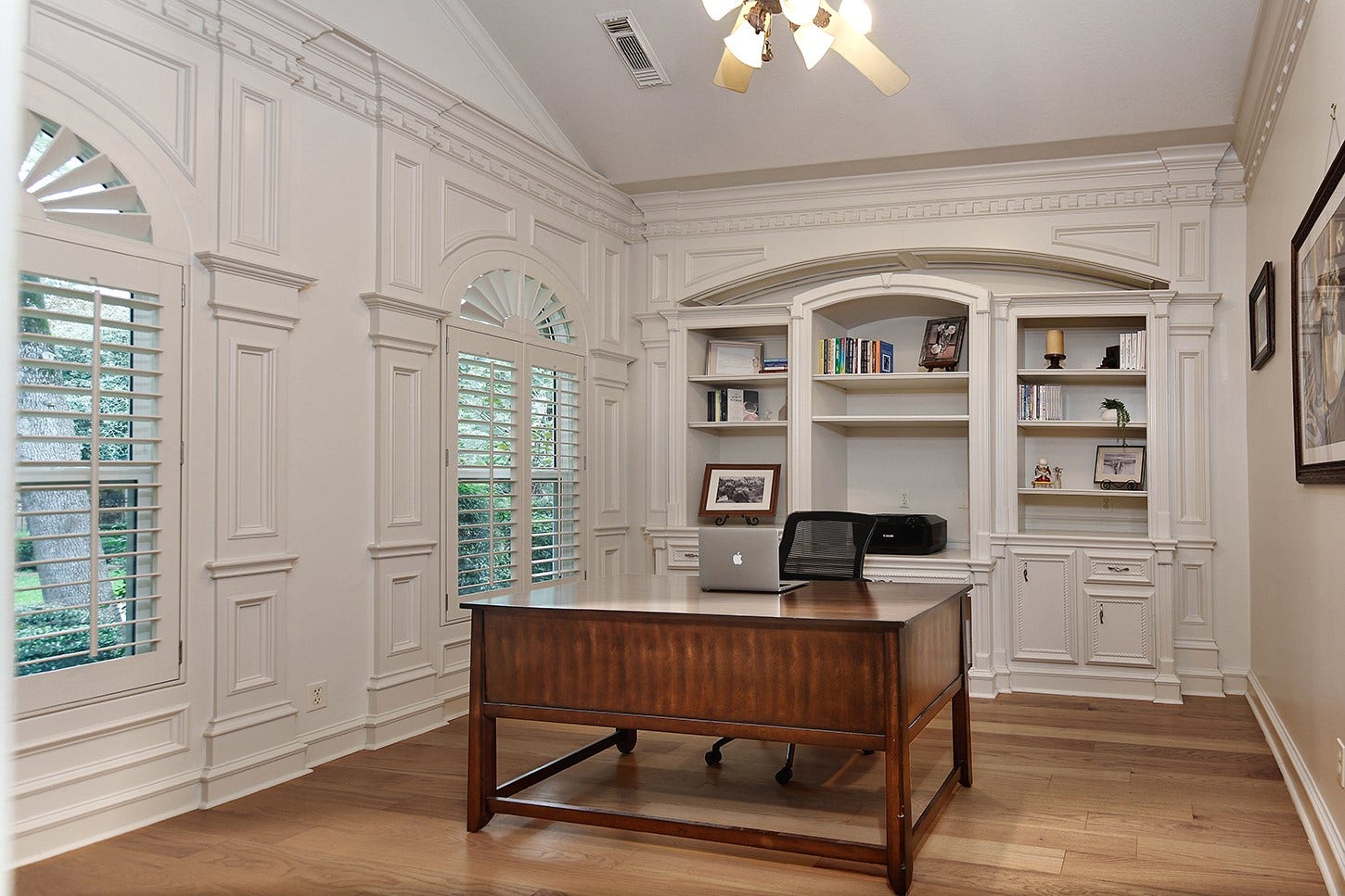 10 Snow Pond Place, The Woodlands, TX 77382 Formal, private study is encased in paneled walls with intricate molding details and built-in custom shelves with cabinets. Wood floors add warmth, depth and texture, and the designer neutral wall color will enhance any decor style.