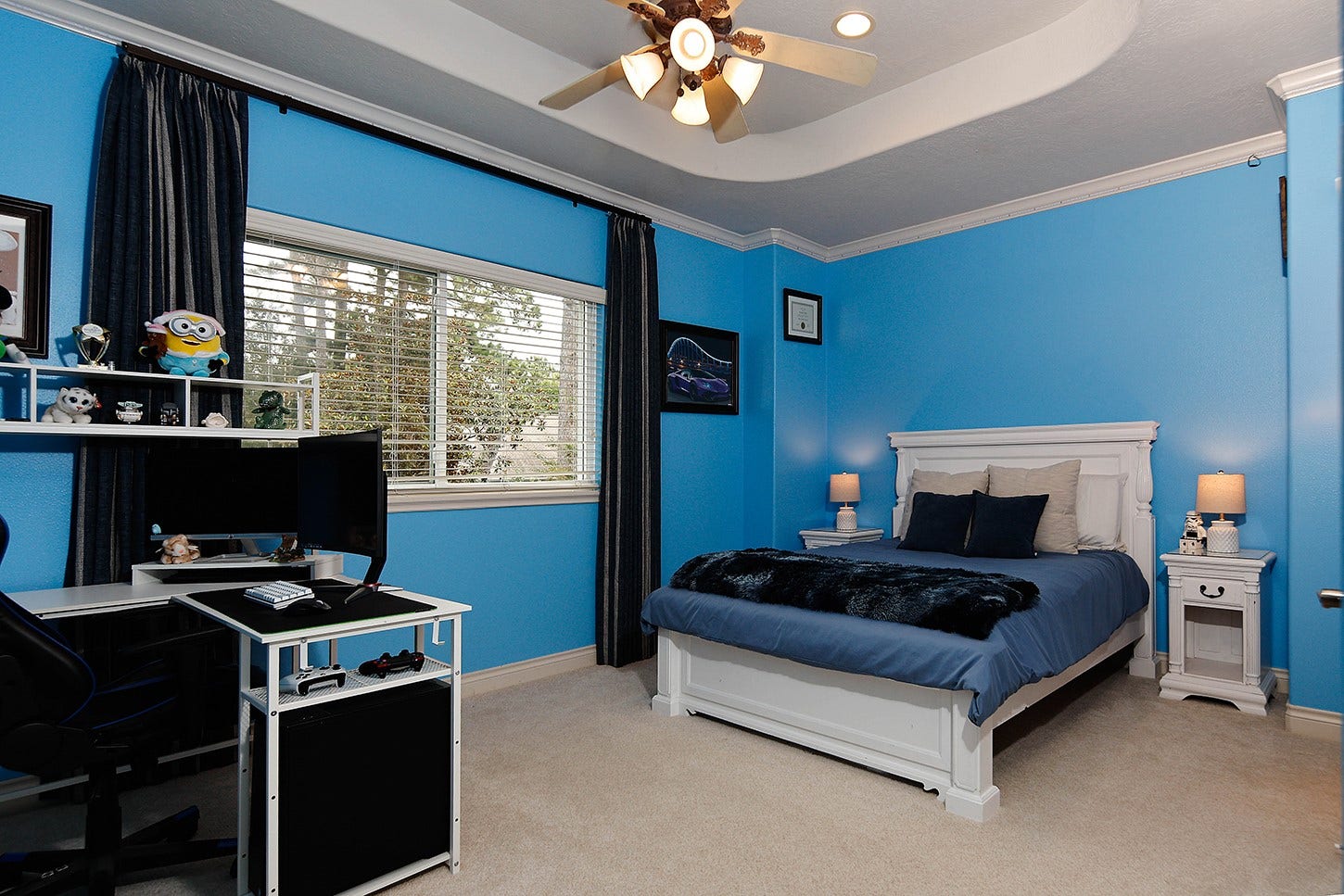 10 Snow Pond Place, The Woodlands, TX 77382 Bedroom 3 features a recessed ceiling, crown molding, large window with drapery, walk-in closet, and vibrant accent walls.