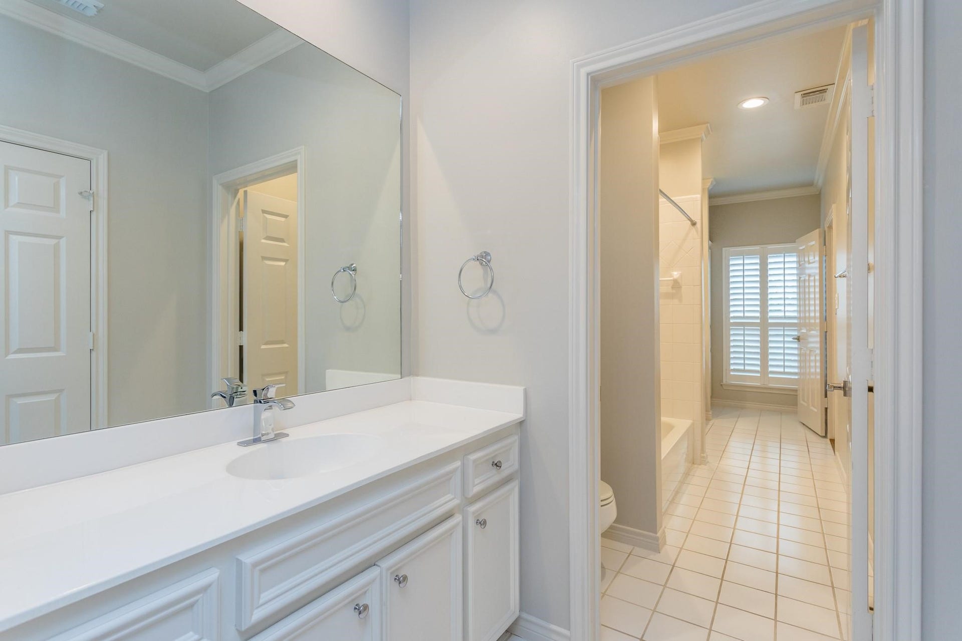 Secondary full bathroom designed as "Jack-and-Jill" layout with separate sinks.