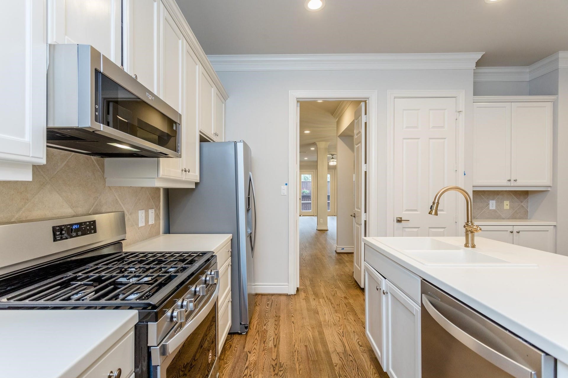 Last look at the kitchen's oversized island and updated stainless steel appliances.