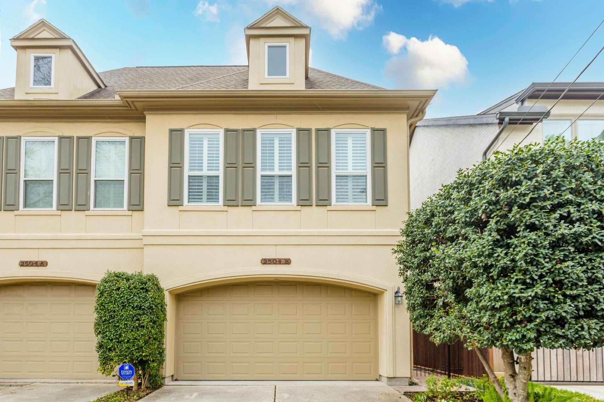 Front exterior featuring double-wide paved driveway.