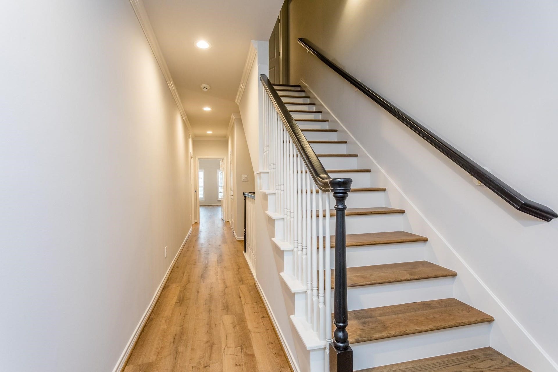 Long second floor hallway allows for increased privacy of primary suite.