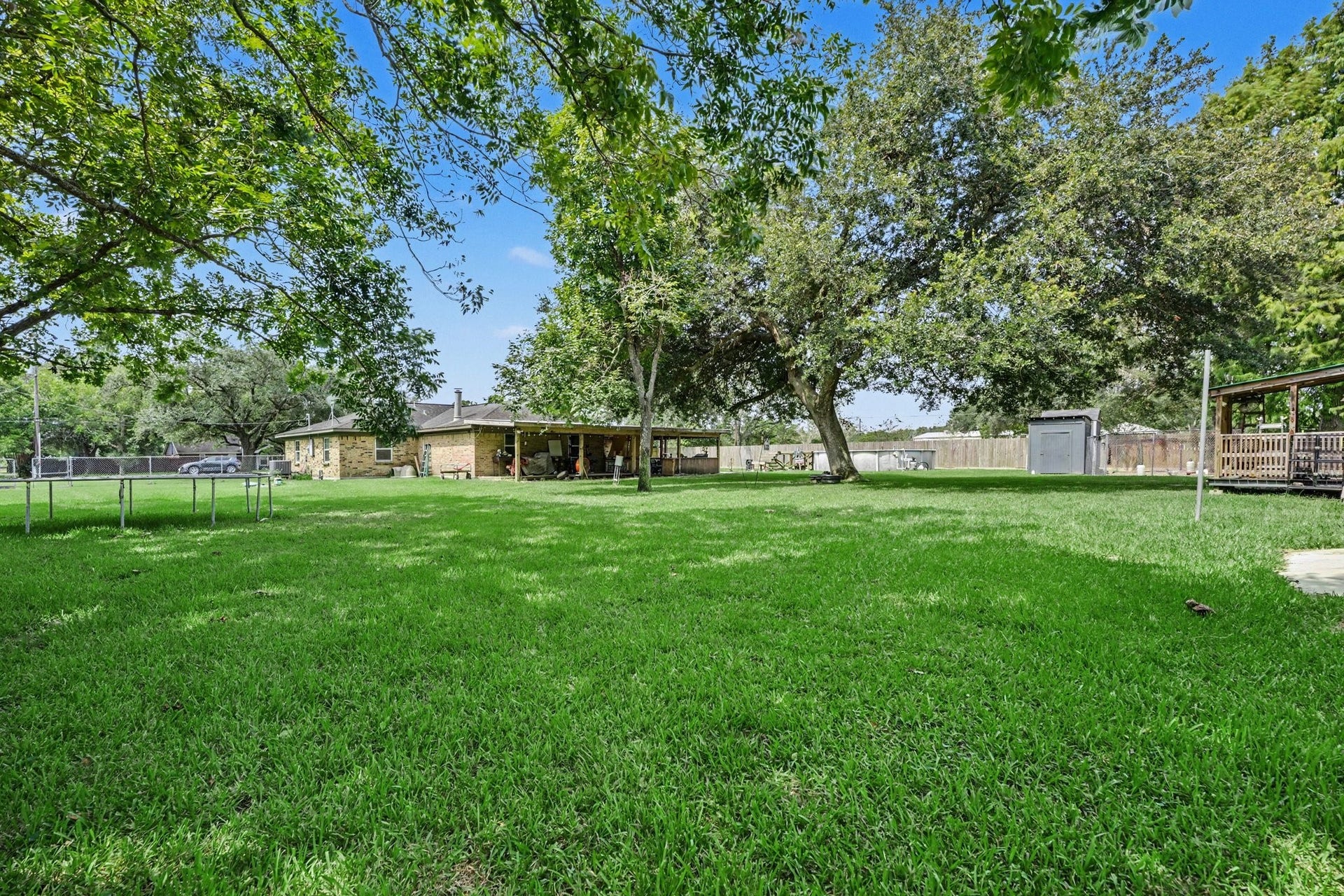 17310 Mcdonald Road, Alvin, TX 77511 Guest house on right, Above ground pool and main house in the middle, and Trampoline on the left with plenty of space to space.