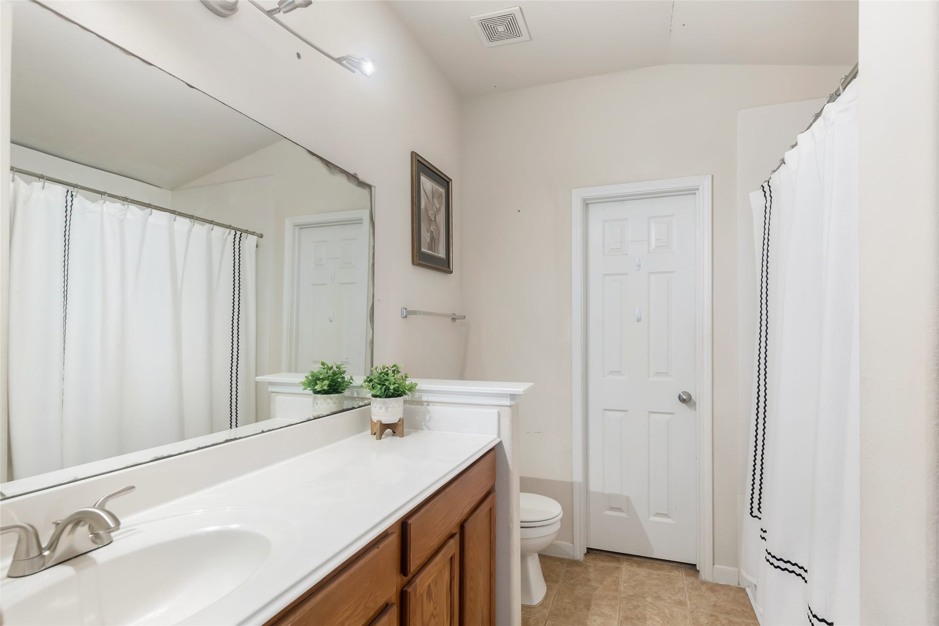 Primary bathroom with a traditional tub and shower combination.
