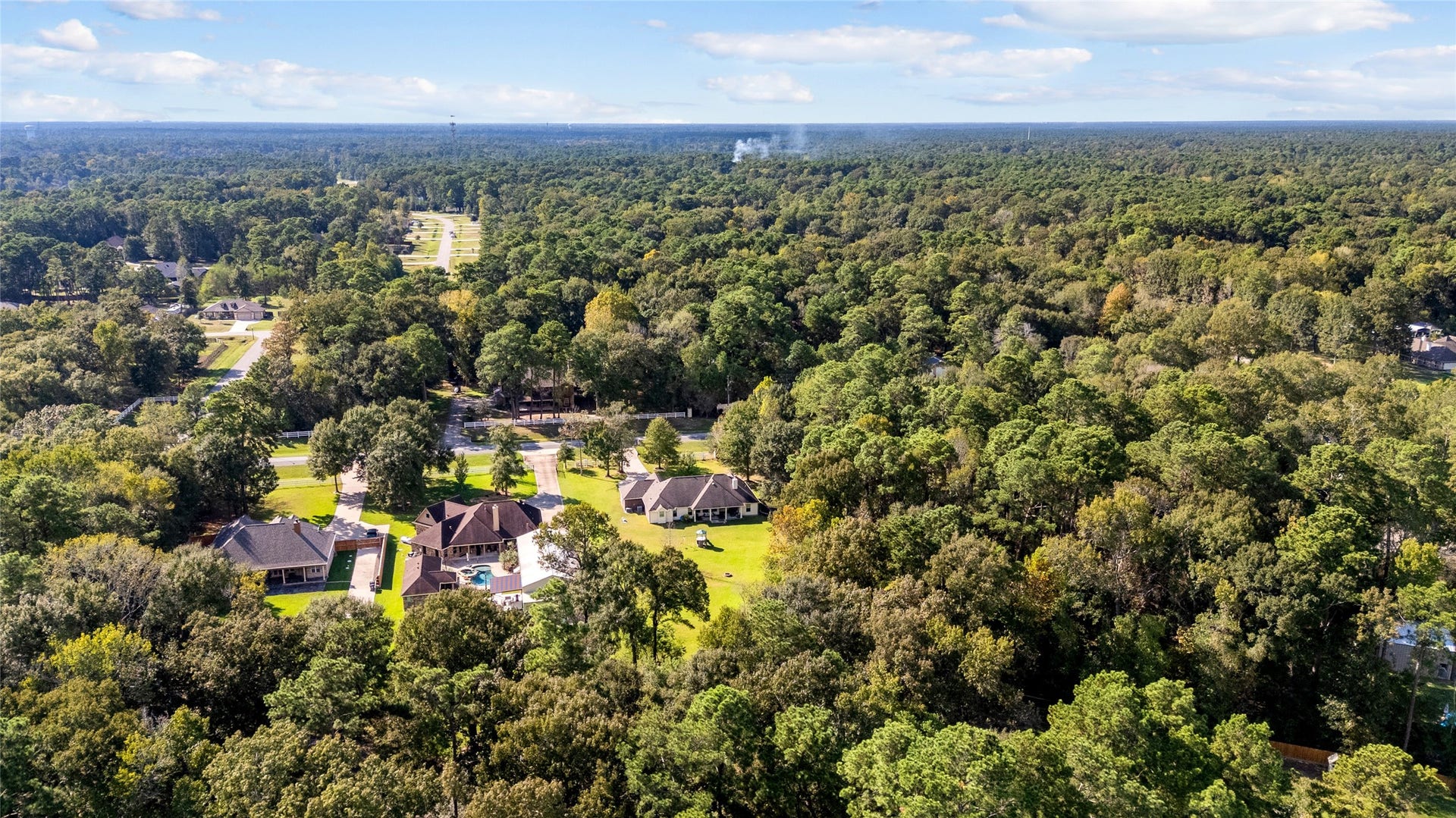 Surrounded by a sea of green! Discover the beauty of a wooded setting where nature takes center stage and privacy is part of the package.