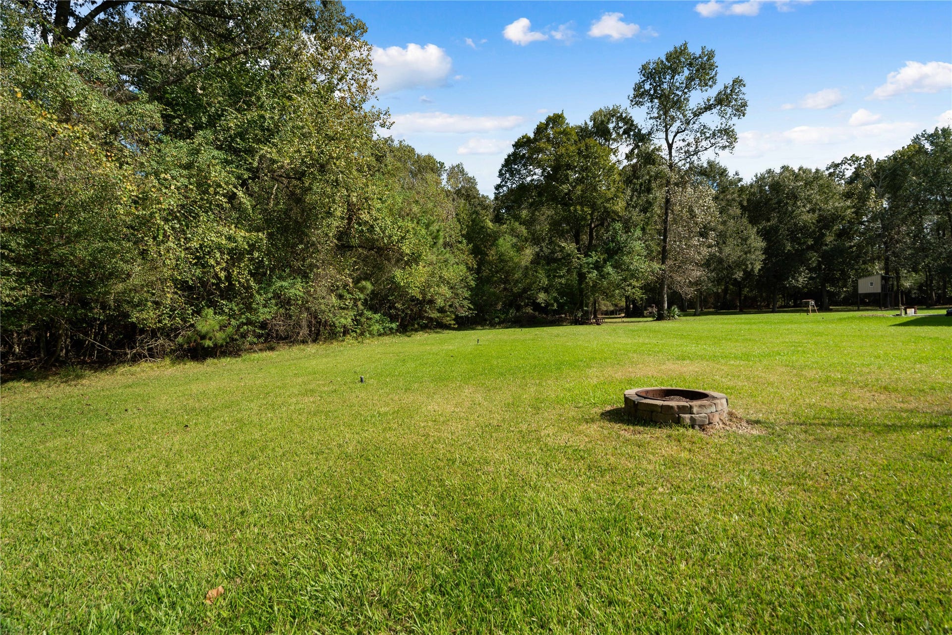 Imagine the possibilities! A beautiful canvas of green grass, mature trees, and wide-open space ready for your outdoor dreams.