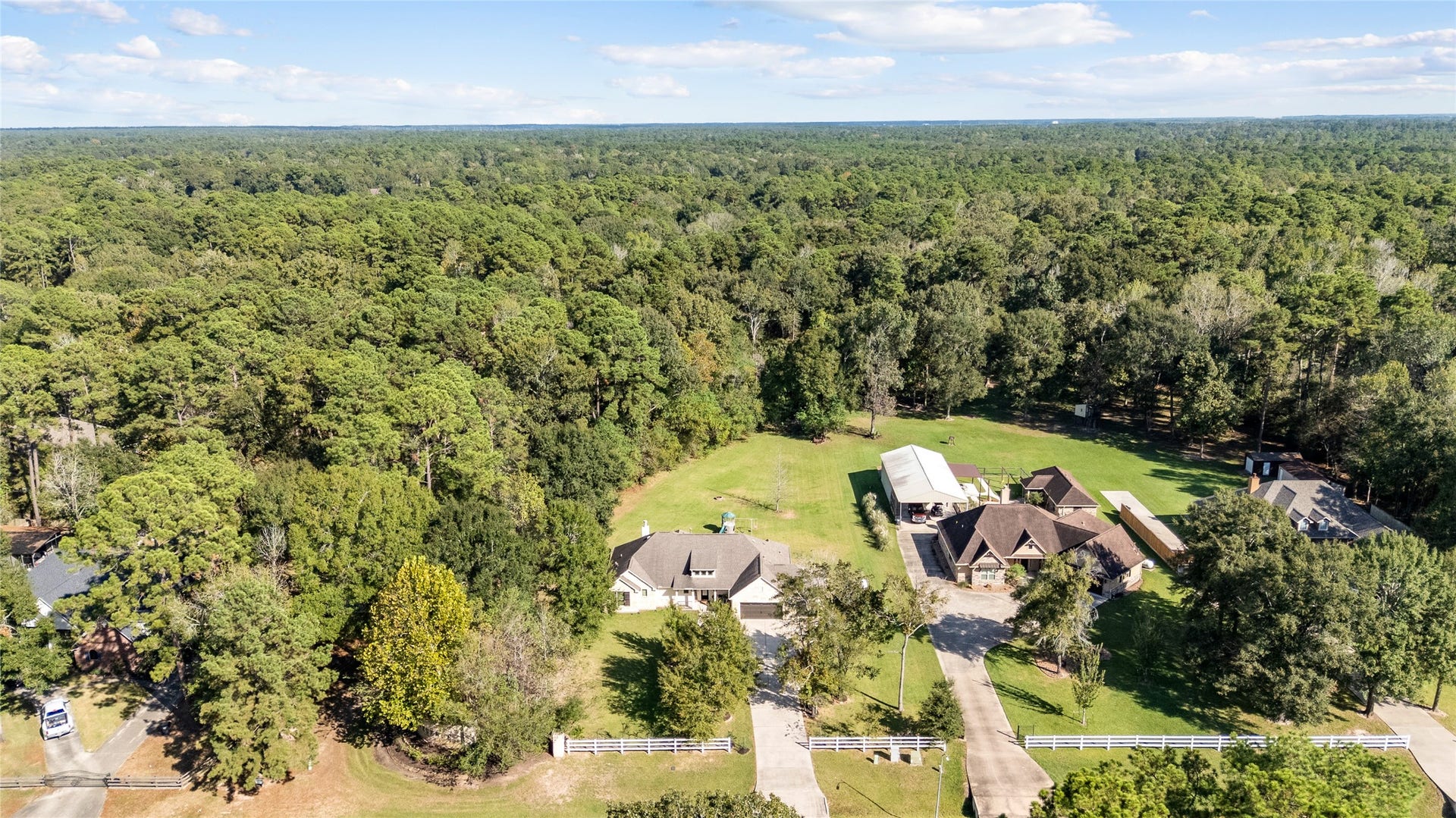 A bird's-eye view of something special! The home sits nestled among mature trees with generous outdoor space to enjoy.