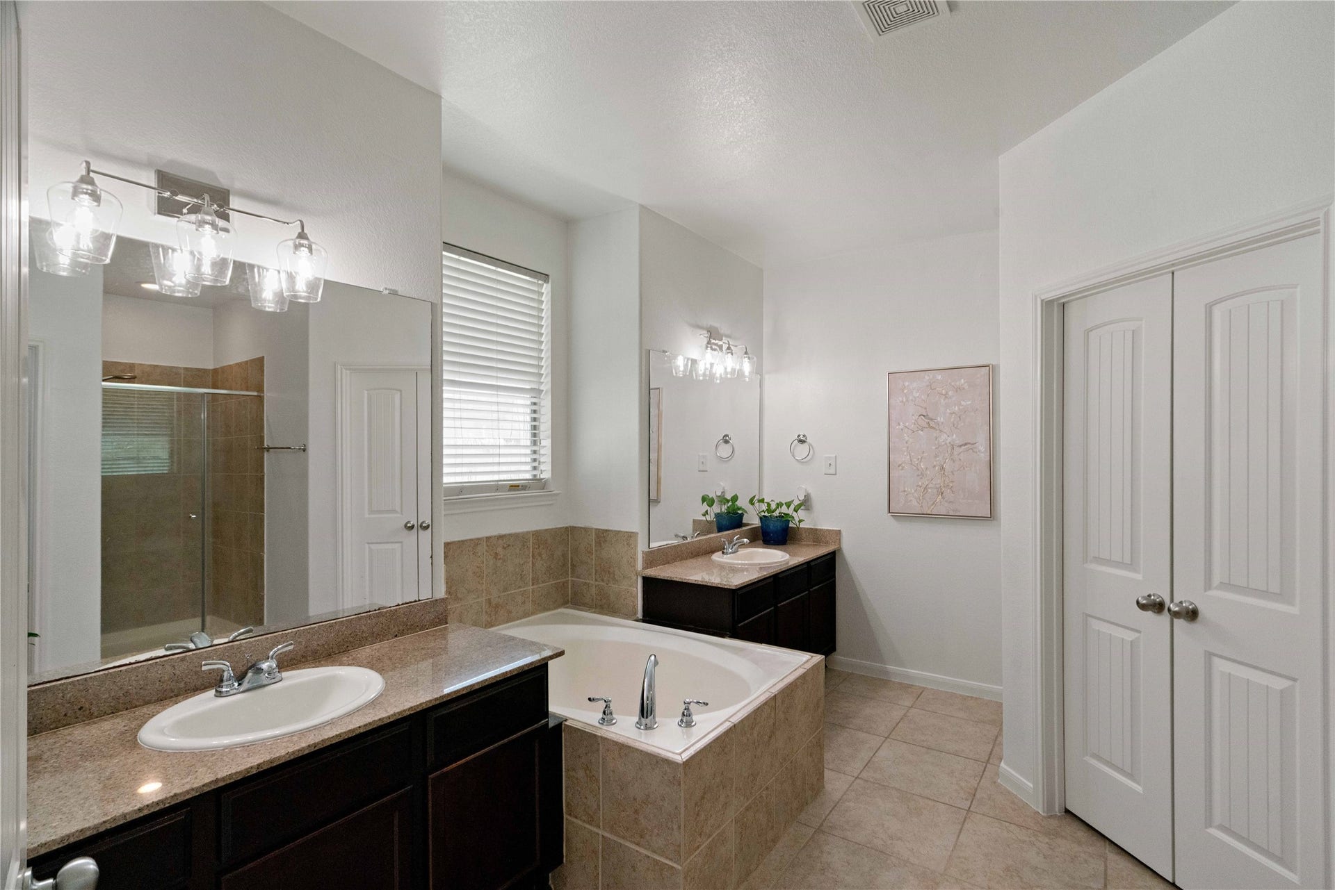 A little everyday luxury! Unwind in the soaking tub or enjoy the convenience of dual vanities in this spacious primary bath.
