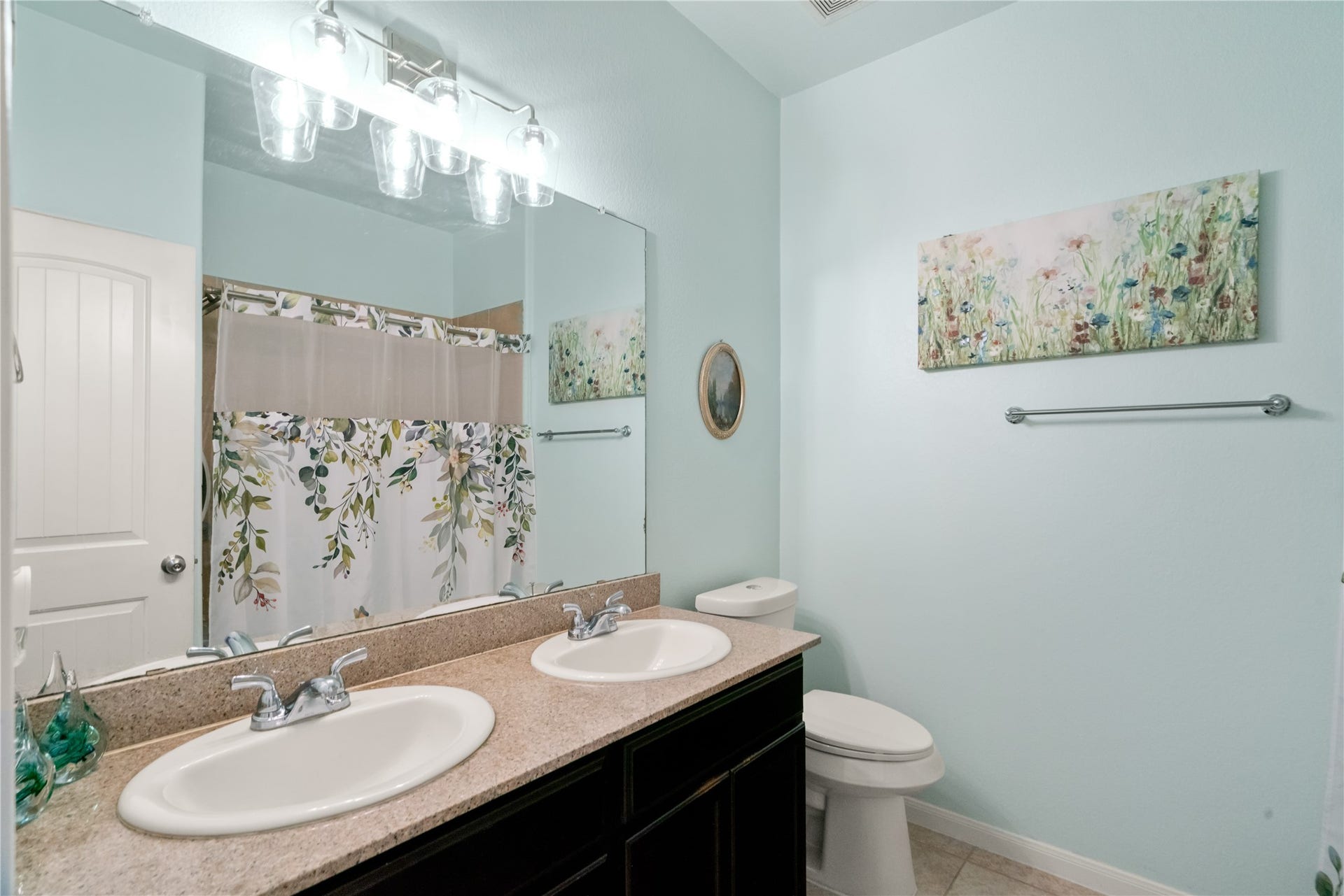 Fresh, cheerful, and functional! This secondary bath offers a spacious vanity and tub/shower combination.
