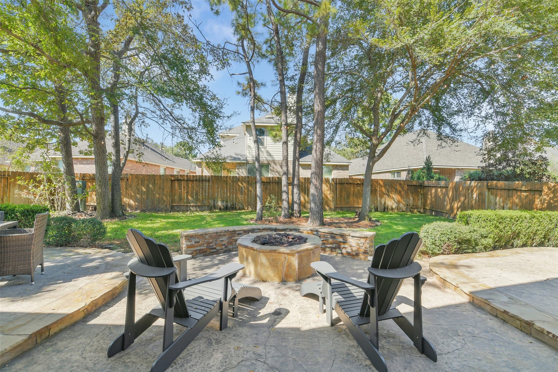 119 Finchfield Place, Montgomery, TX 77316 Spacious backyard patio surrounded by mature trees and attractive landscaping.