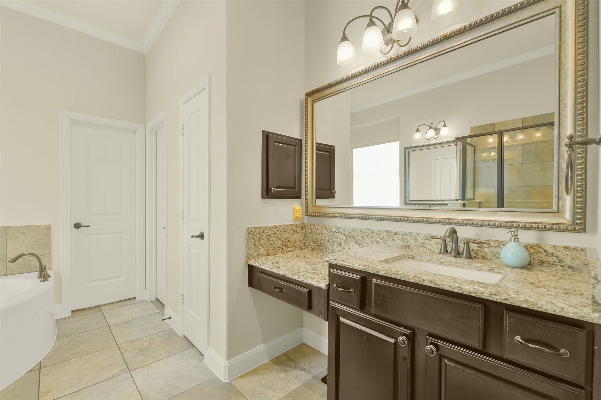 119 Finchfield Place, Montgomery, TX 77316 Dual vanities with generous counter space, framed mirrors, and ample cabinetry.