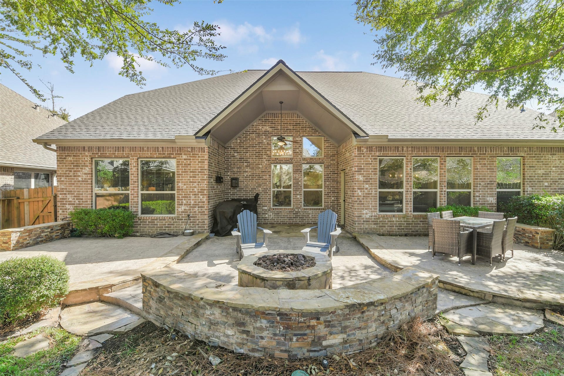 119 Finchfield Place, Montgomery, TX 77316 Stunning rear elevation showcasing the home's brick exterior, outdoor living areas, and attractive landscaping.