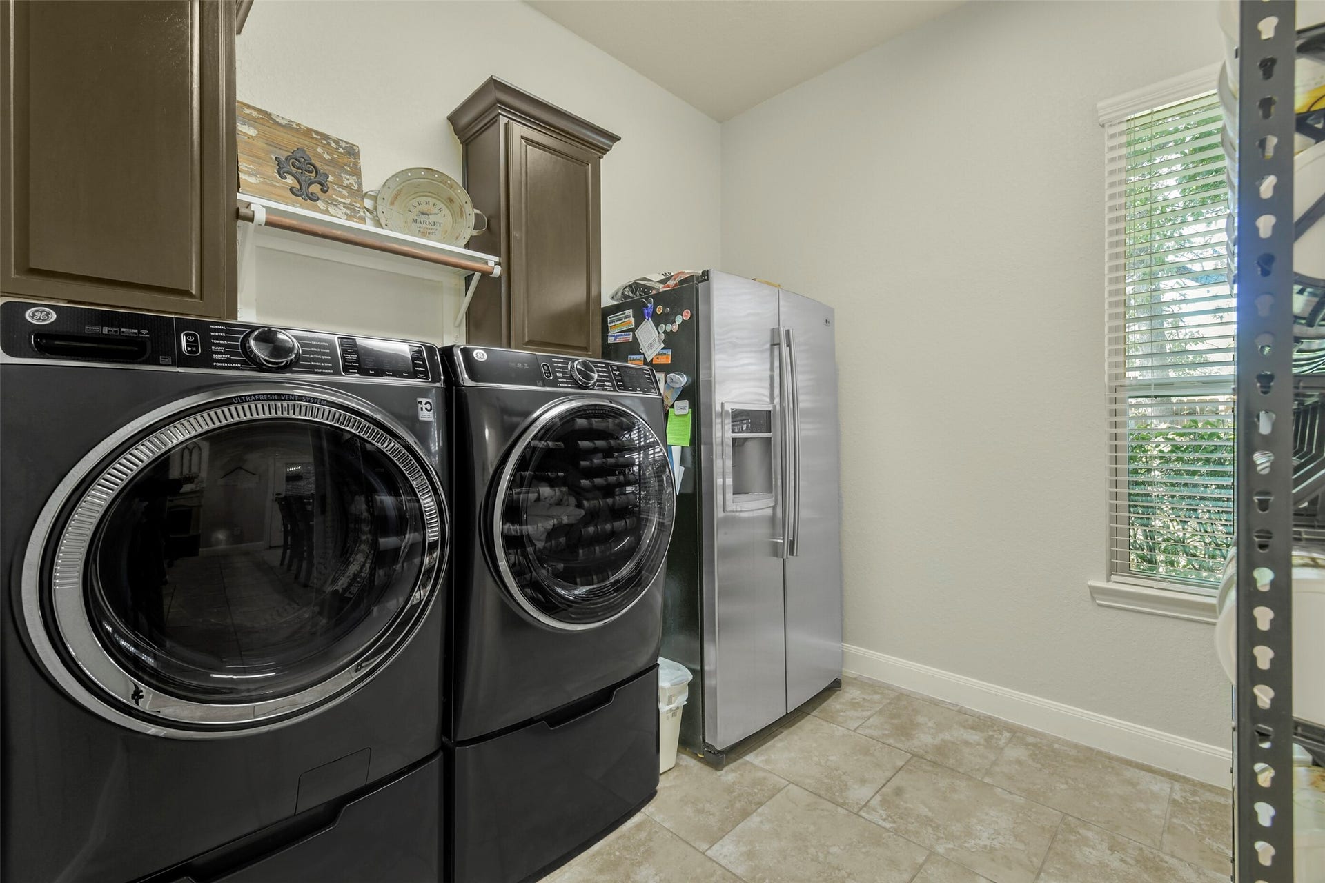 119 Finchfield Place, Montgomery, TX 77316 Convenient laundry room with space for full-size appliances, cabinetry, and additional storage.