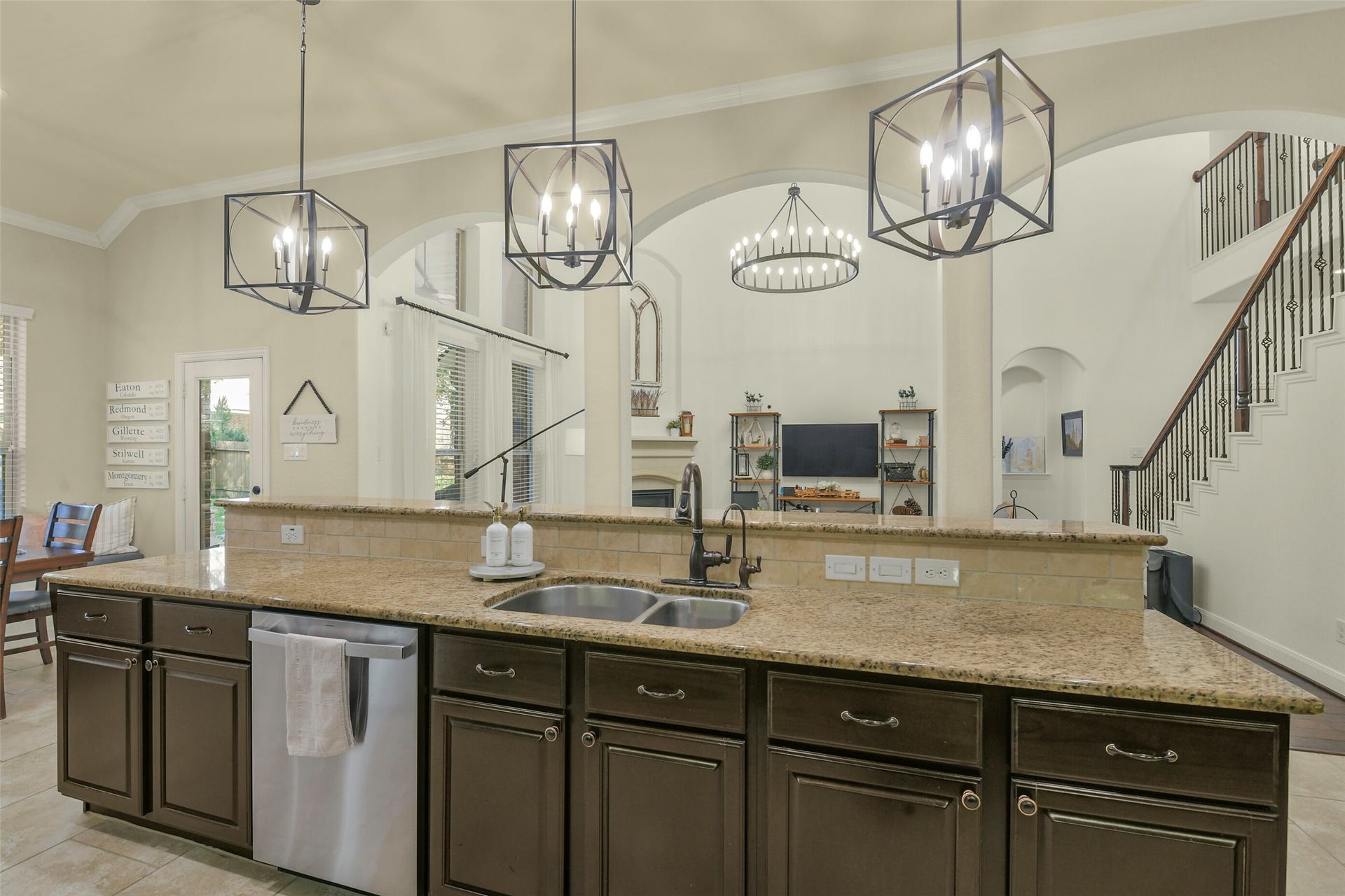 119 Finchfield Place, Montgomery, TX 77316 Large kitchen island with seating, pendant lighting, and an open view into the family room.