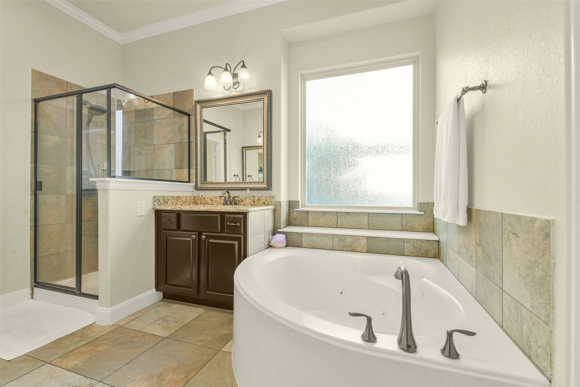 119 Finchfield Place, Montgomery, TX 77316 Relaxing soaking tub positioned beneath a window, with a separate shower and vanity area.