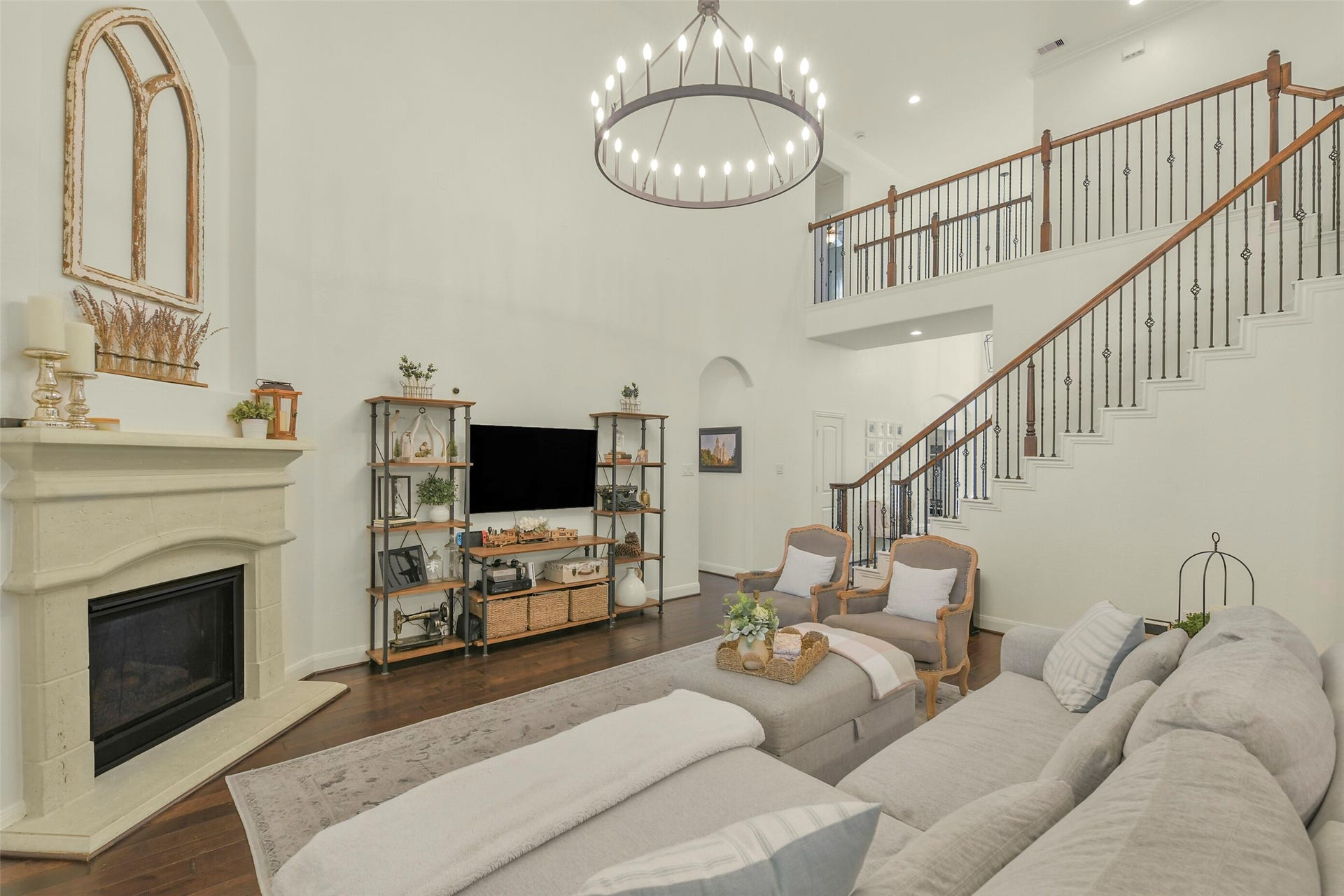 119 Finchfield Place, Montgomery, TX 77316 Open-concept living room showcasing the fireplace, staircase, and beautiful architectural details.