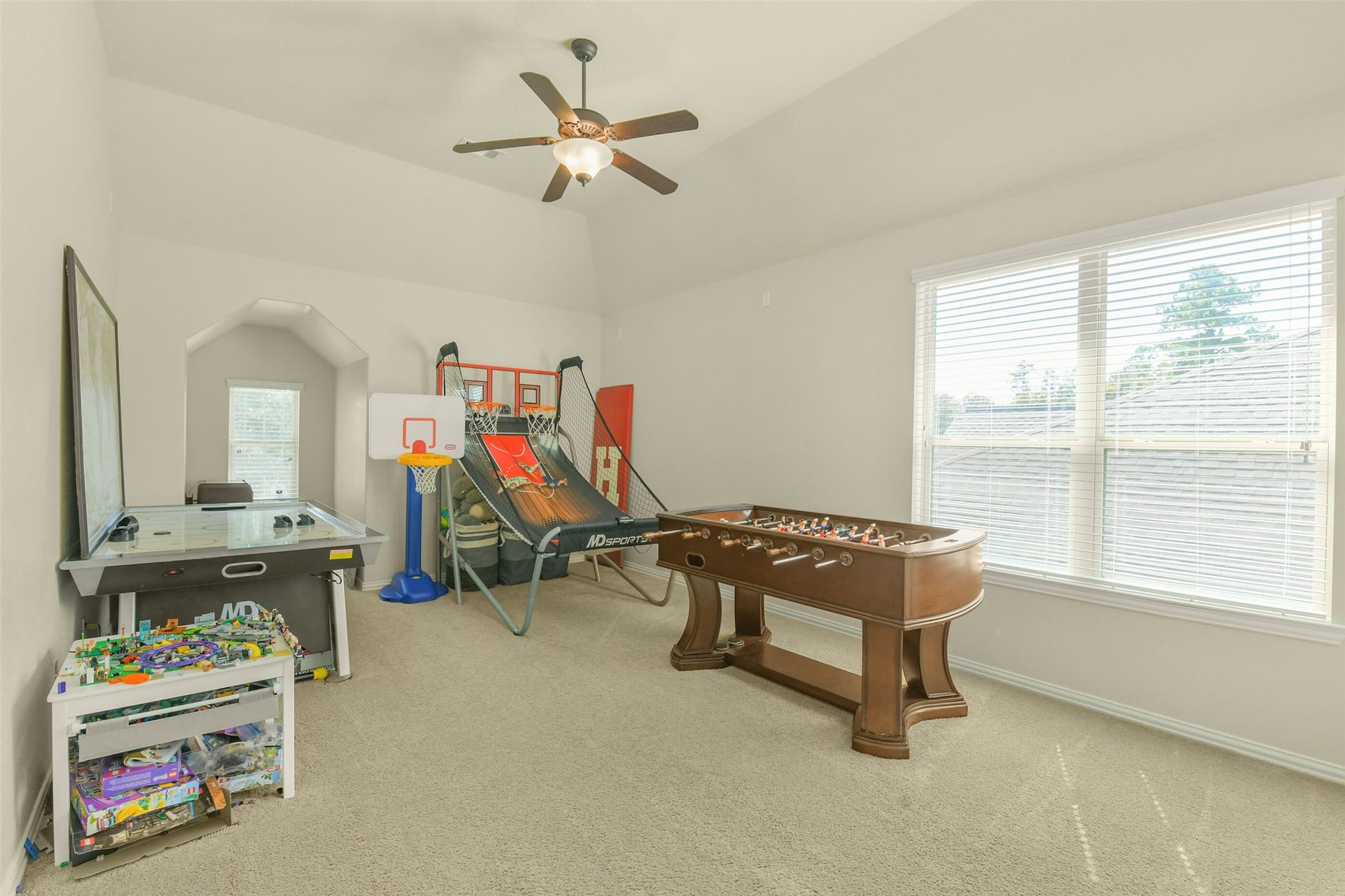 119 Finchfield Place, Montgomery, TX 77316 Spacious secondary bedroom featuring neutral carpeting, ceiling fan, and large windows.