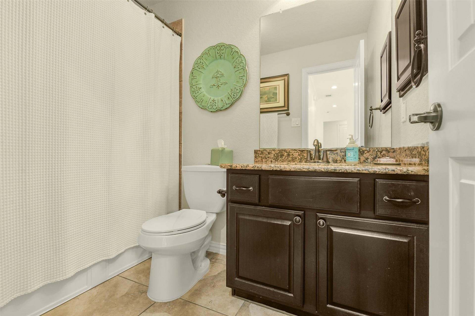 119 Finchfield Place, Montgomery, TX 77316 Secondary bathroom featuring a spacious vanity, framed mirror, and storage cabinetry.