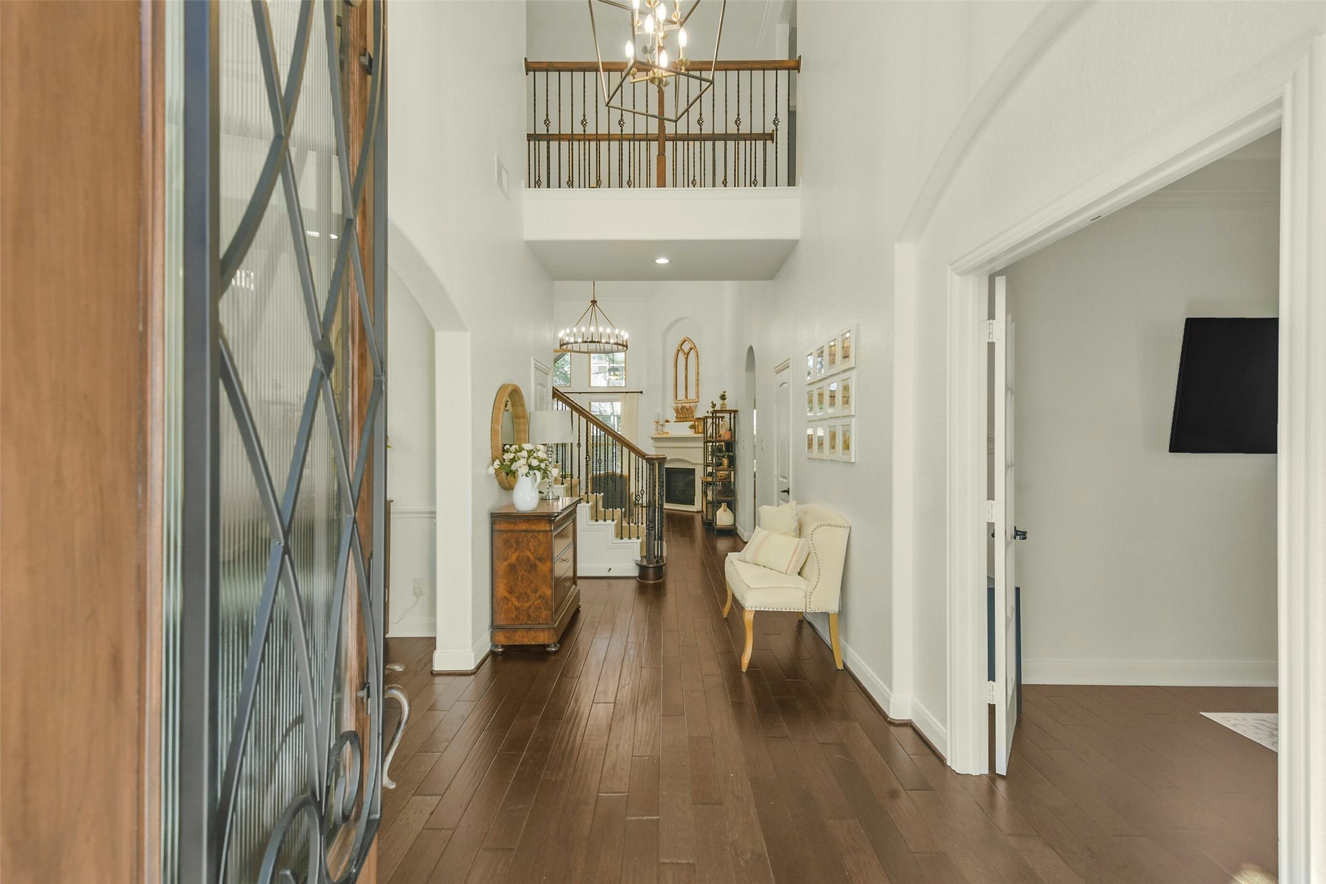 119 Finchfield Place, Montgomery, TX 77316 Elegant entryway featuring rich wood flooring, soaring ceilings, and a view into the home's open living spaces.