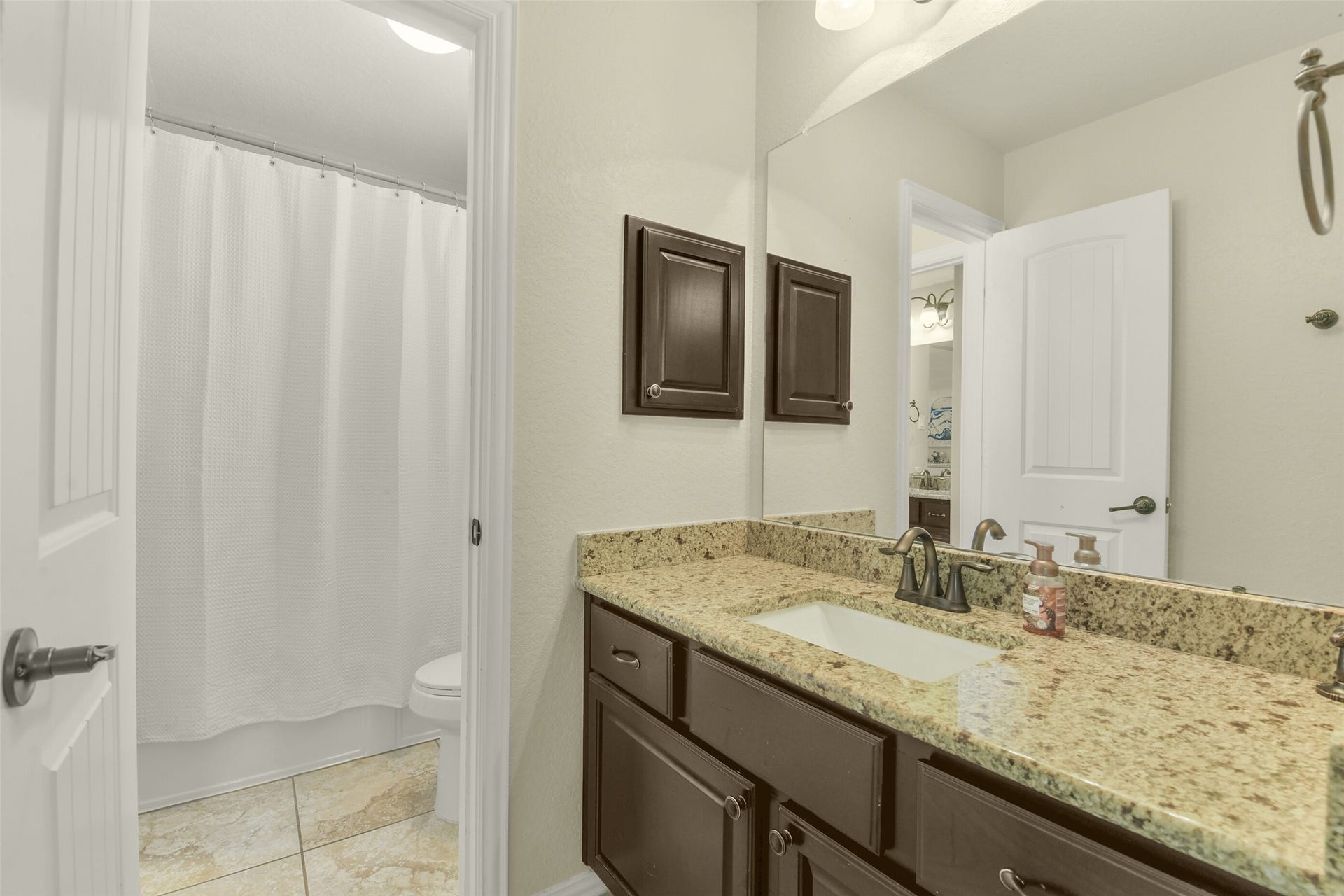 119 Finchfield Place, Montgomery, TX 77316 Bathroom vanity with abundant counter space, decorative lighting, and storage cabinetry.