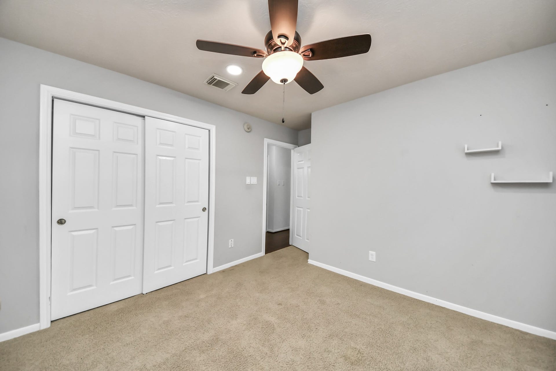 Another view of the secondary bedroom showing the closet and room for your furniture.