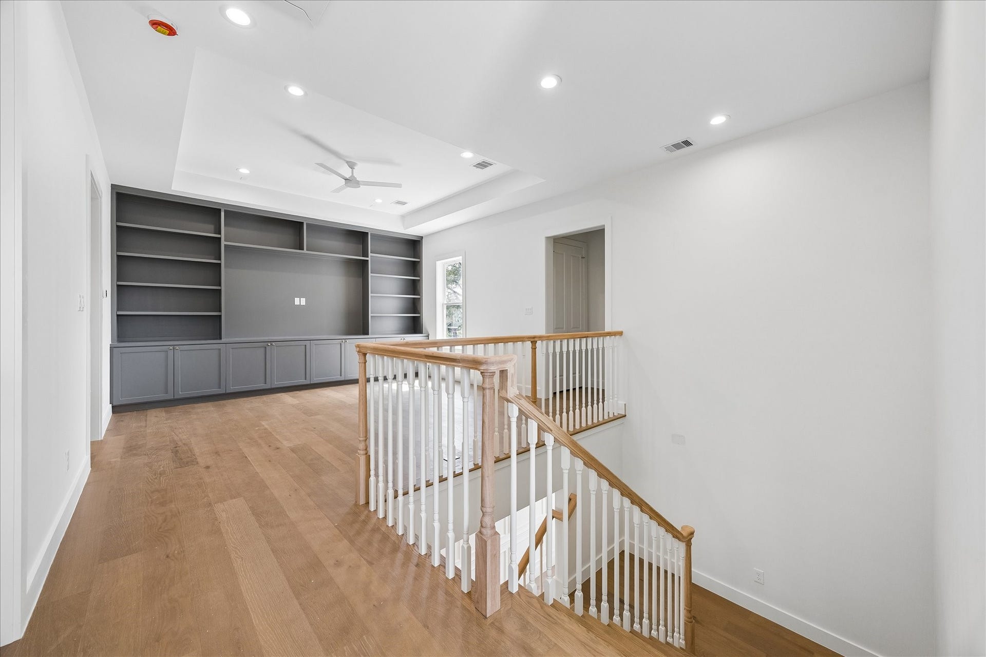 1726 Chantilly Lane, Houston, TX 77018 The upstairs landing opens to the game room beside the staircase. Wood flooring and built-in storage continue the homes finish palette into this additional living space.