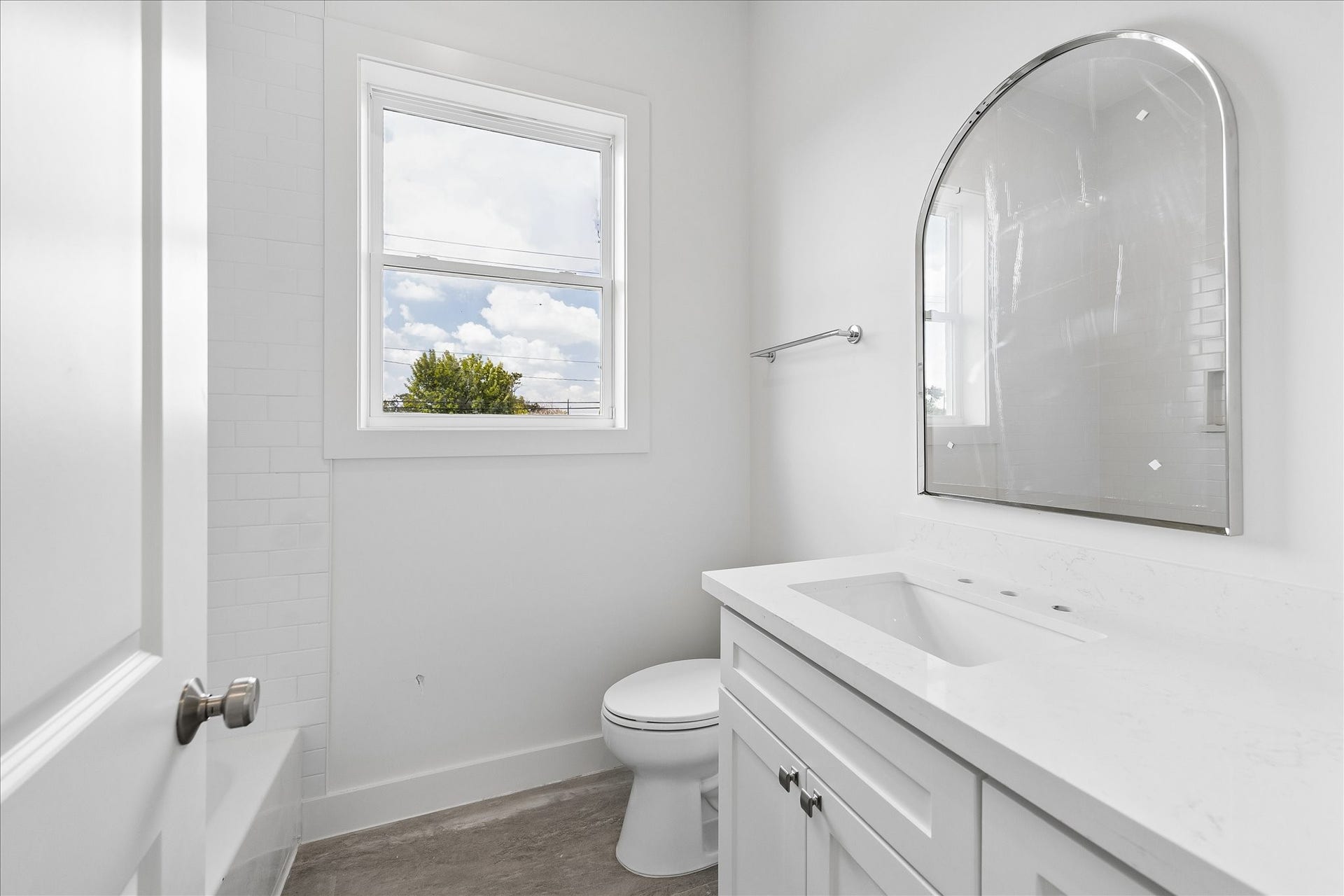 1726 Chantilly Lane, Houston, TX 77018 A secondary bathroom features a vanity with cabinet storage and a light counter. The coordinated mirror and fixtures keep the space clean and practical.