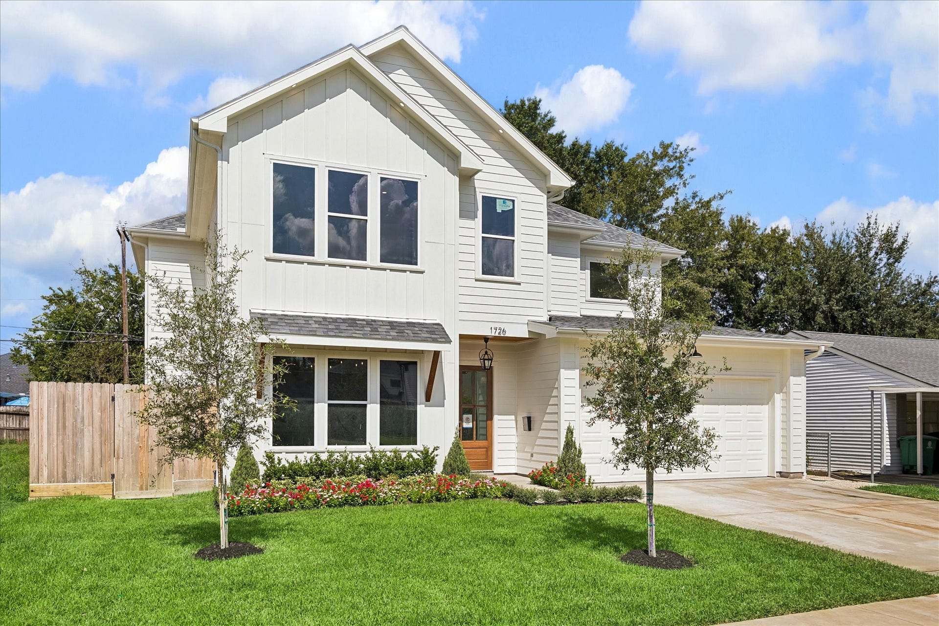 1726 Chantilly Lane, Houston, TX 77018 This angled view highlights the two-story facade, attached garage and recessed front entry. Horizontal siding and vertical accents give the exterior a layered composition.