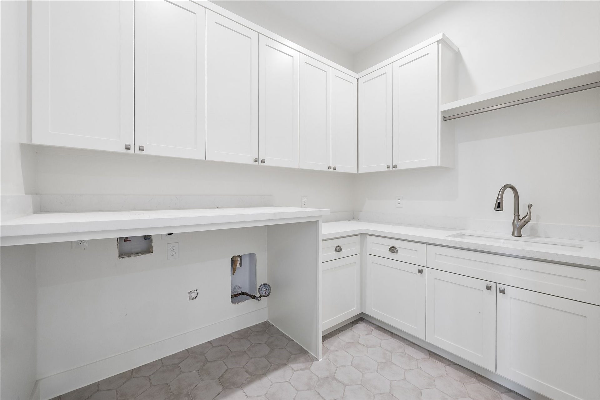 1726 Chantilly Lane, Houston, TX 77018 The upstairs utility room includes cabinetry, a sink and washer and dryer connections. Tile flooring and counter space support laundry and household organization; appliances are not shown.