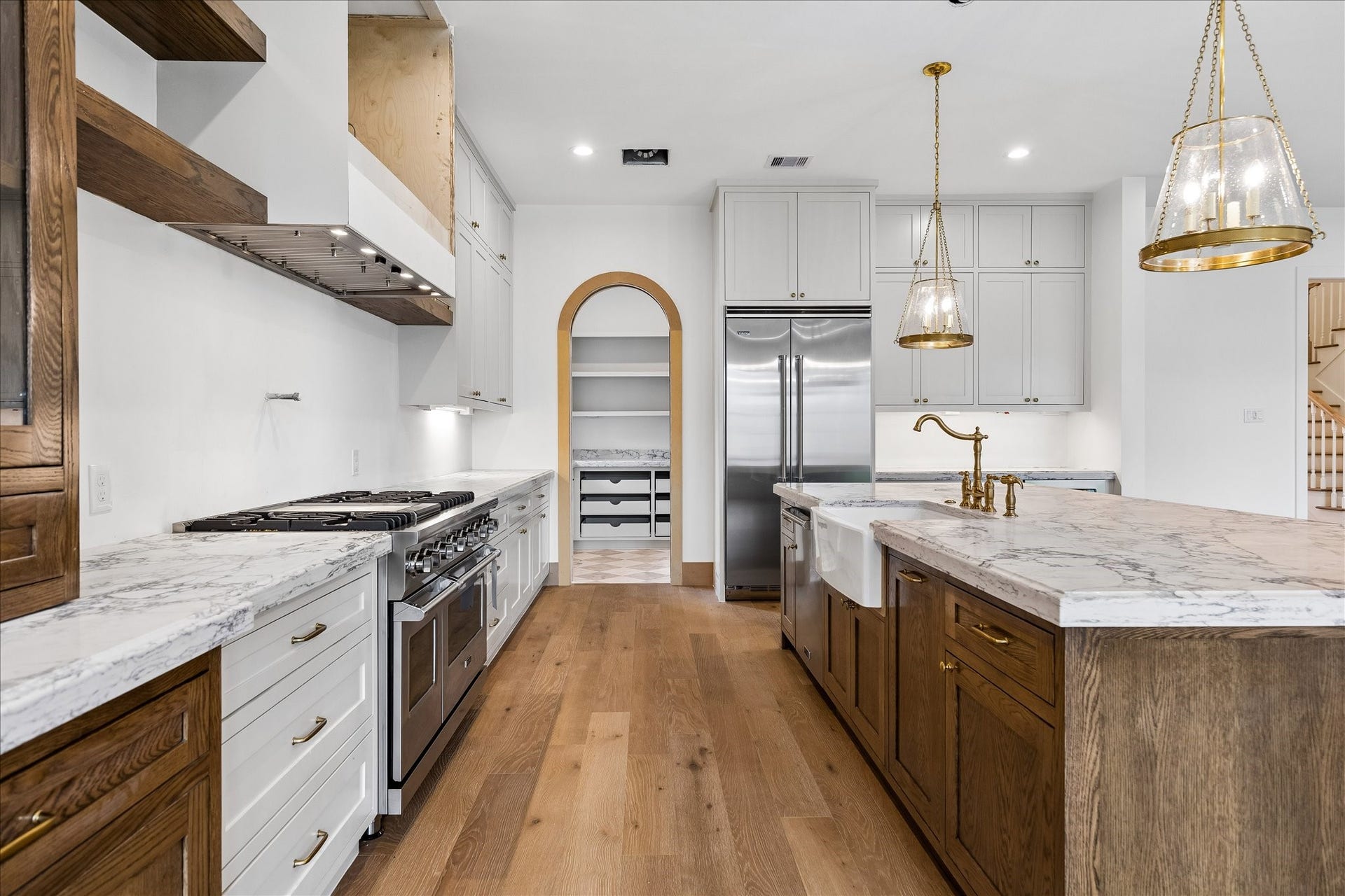 1726 Chantilly Lane, Houston, TX 77018 The island kitchen pairs light cabinetry with warm wood details and stainless appliances. Broad counters and an open layout keep preparation, serving and conversation connected.