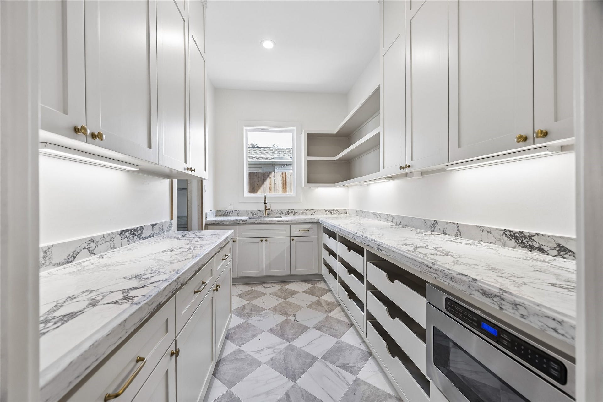 1726 Chantilly Lane, Houston, TX 77018 The separate prep kitchen and pantry provide additional counters, cabinetry and a second sink. A microwave drawer, under-cabinet lighting and checkerboard flooring complete this practical workspace.