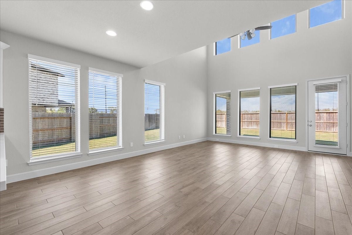 19007 Satsuma Ridge Drive, Manvel, TX 77578 The kitchen opens to a 2 story dining and living area.